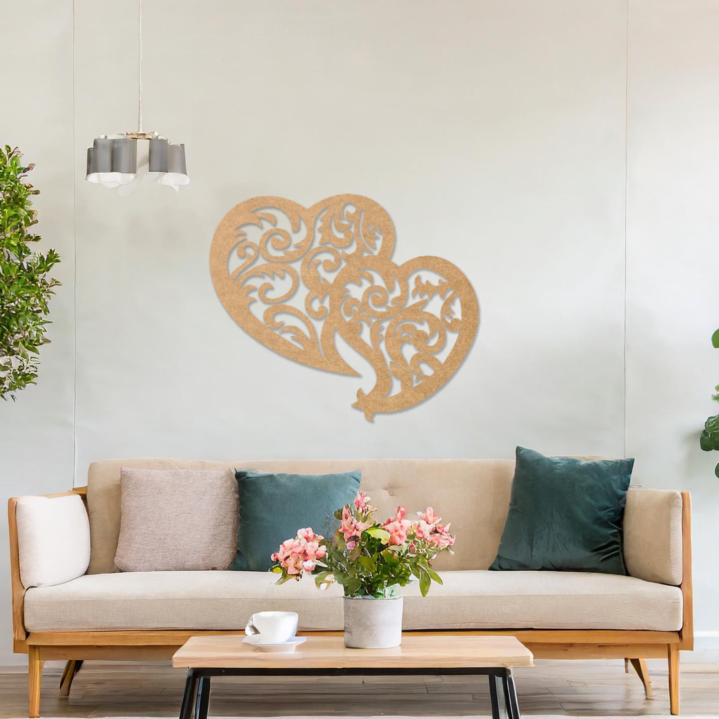 Wooden wall art design featuring two interlocking hearts with intricate swirling patterns, placed on a neutral wall within modern room decor. The design combines elegance and romance with its flowing shapes and fine details.