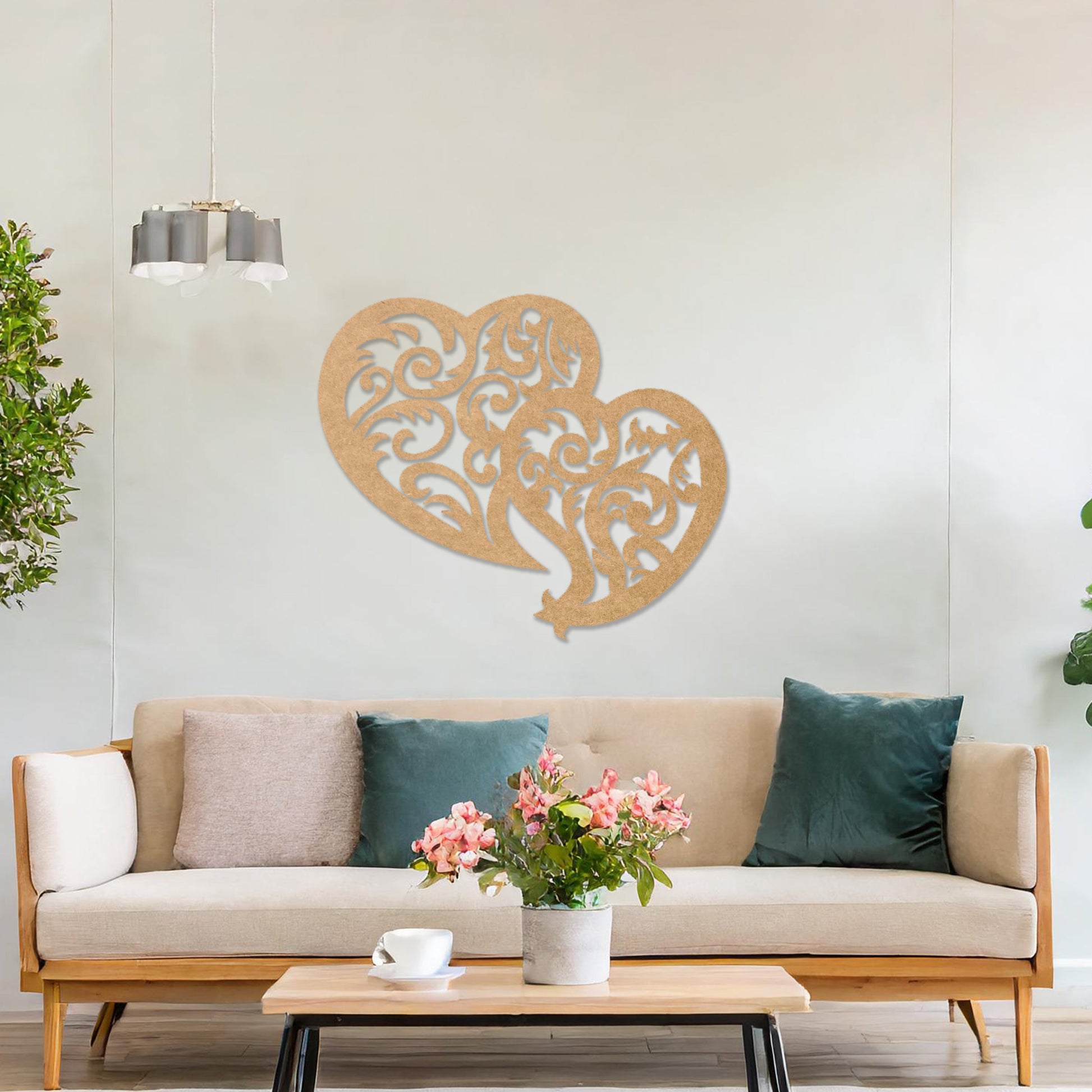Wooden wall art design featuring two interlocking hearts with intricate swirling patterns, placed on a neutral wall within modern room decor. The design combines elegance and romance with its flowing shapes and fine details.