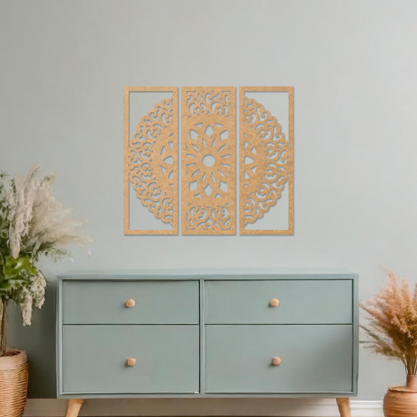 Wall art featuring a triptych design with an intricate mandala pattern framed across three panels. The artwork is displayed on a neutral wall within modern decor, adding a harmonious and decorative element to the space.