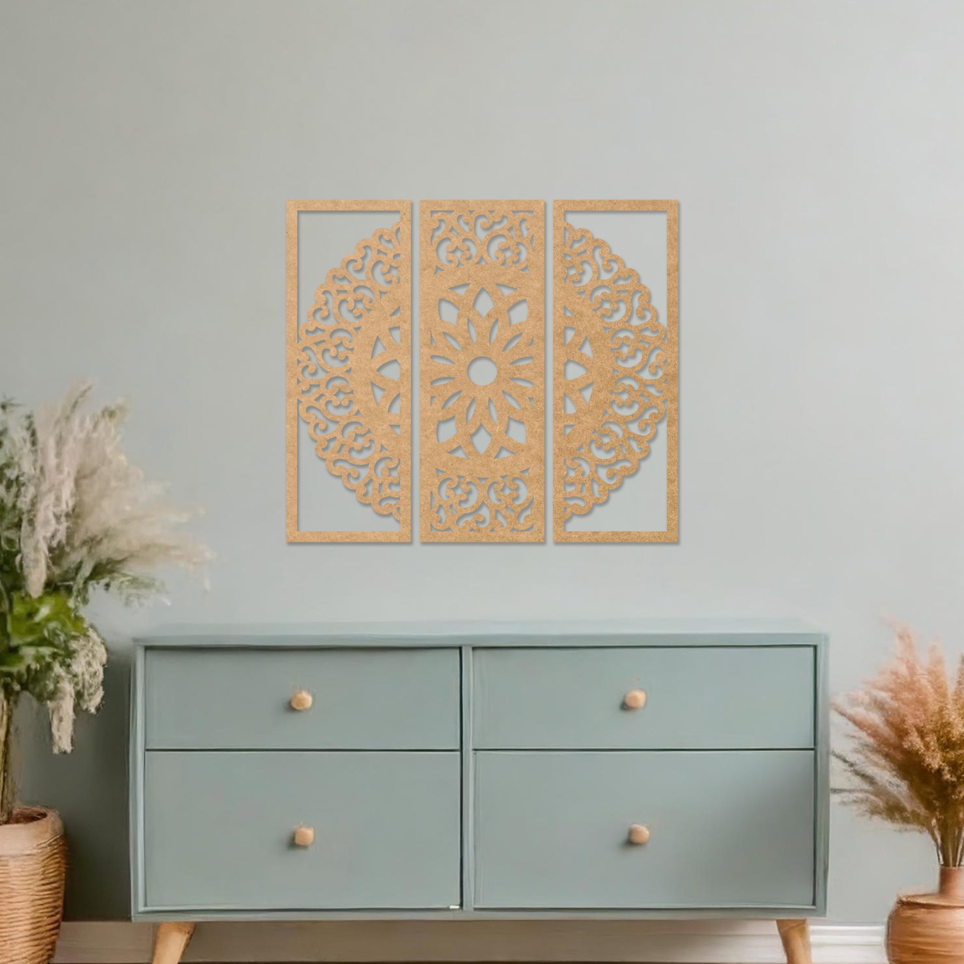 Wall art featuring a triptych design with an intricate mandala pattern framed across three panels. The artwork is displayed on a neutral wall within modern decor, adding a harmonious and decorative element to the space.