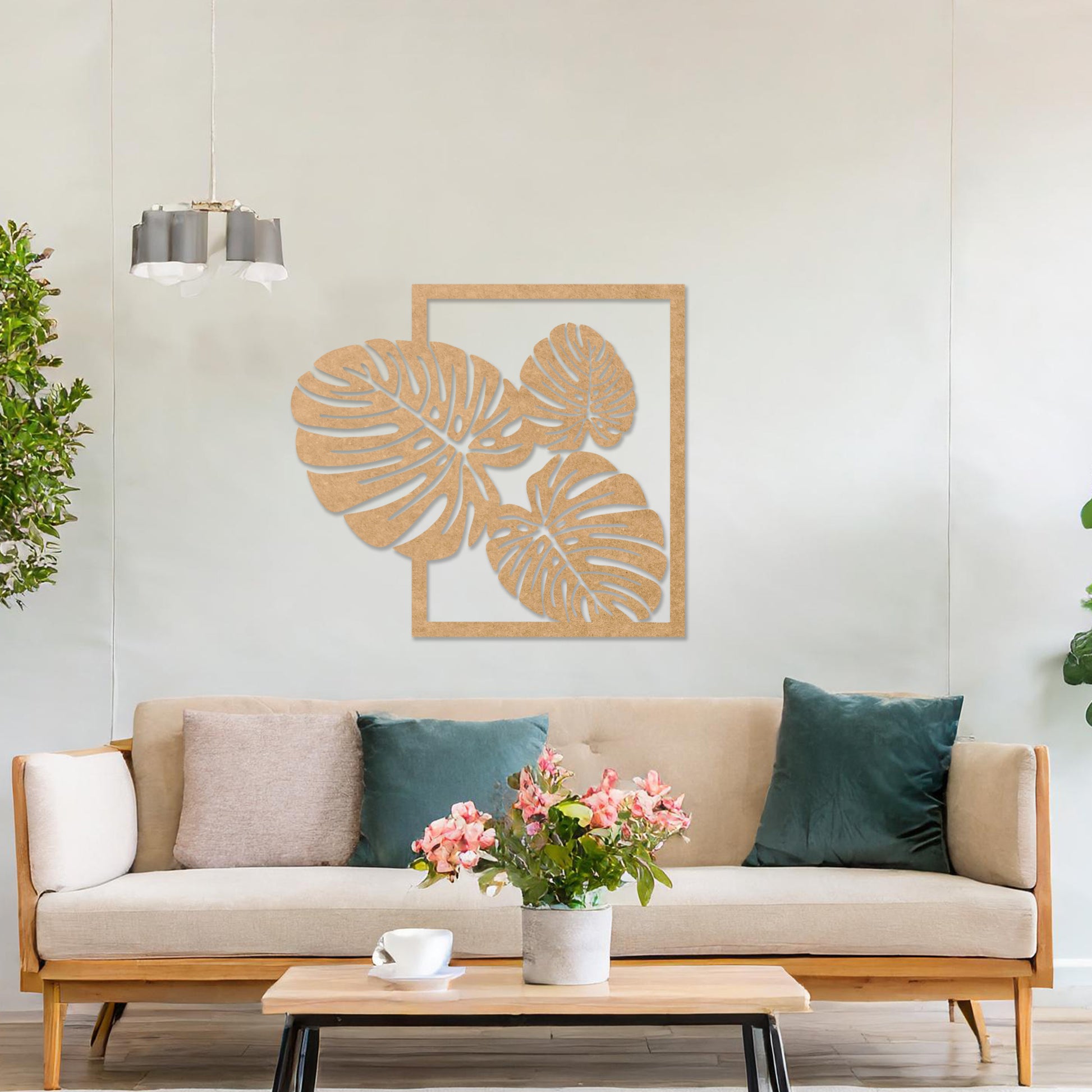 Wall art featuring a botanical design of overlapping monstera leaves framed within a rectangular border. The piece is displayed on a neutral wall within modern room decor, enhancing the natural and elegant aesthetic.