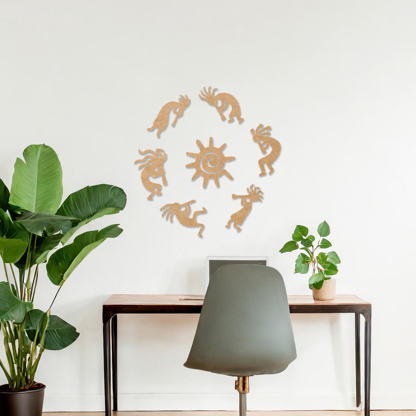 Wooden wall art featuring a circular arrangement of dancing figures surrounding a central sun design. The artwork is displayed on a neutral wall within modern room decor, highlighting its tribal and artistic charm.