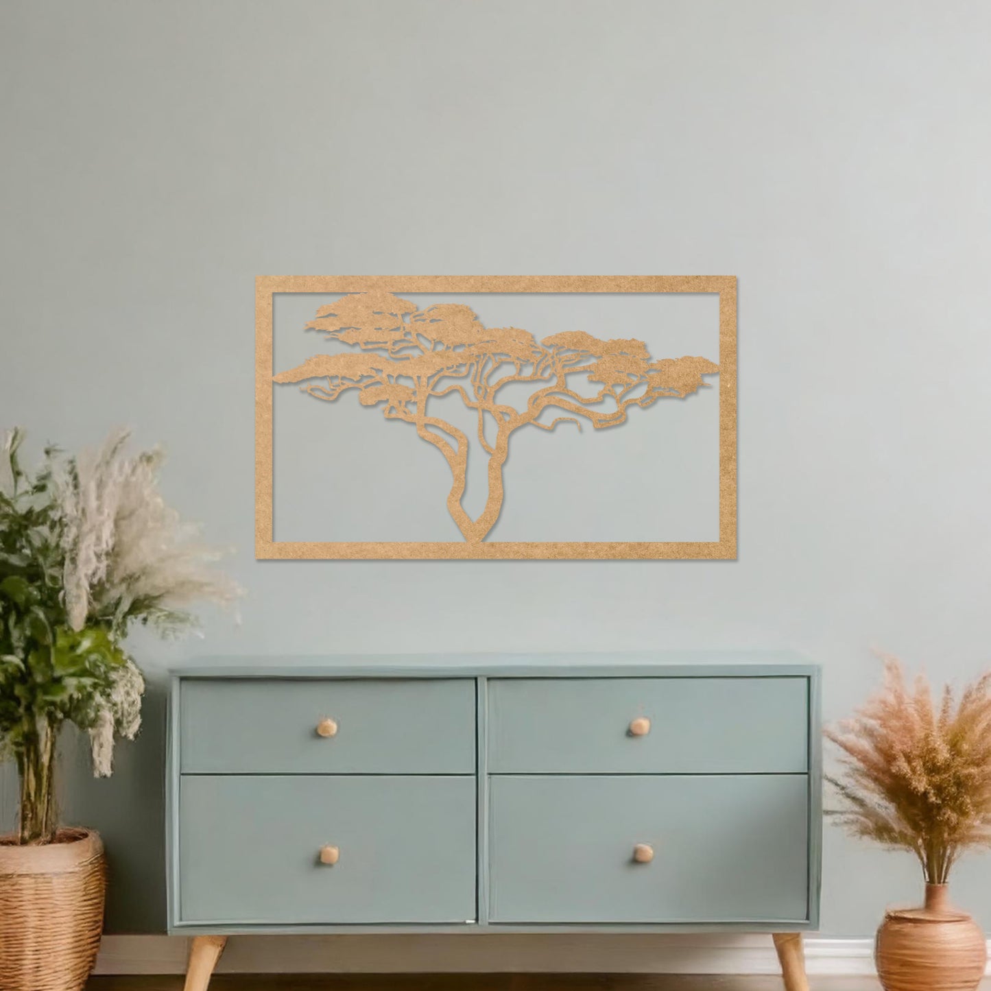 Wooden wall art featuring a rectangular design with a detailed silhouette of a tree with sprawling branches. The artwork is displayed on a neutral wall within modern room decor, showcasing its natural and artistic elegance.