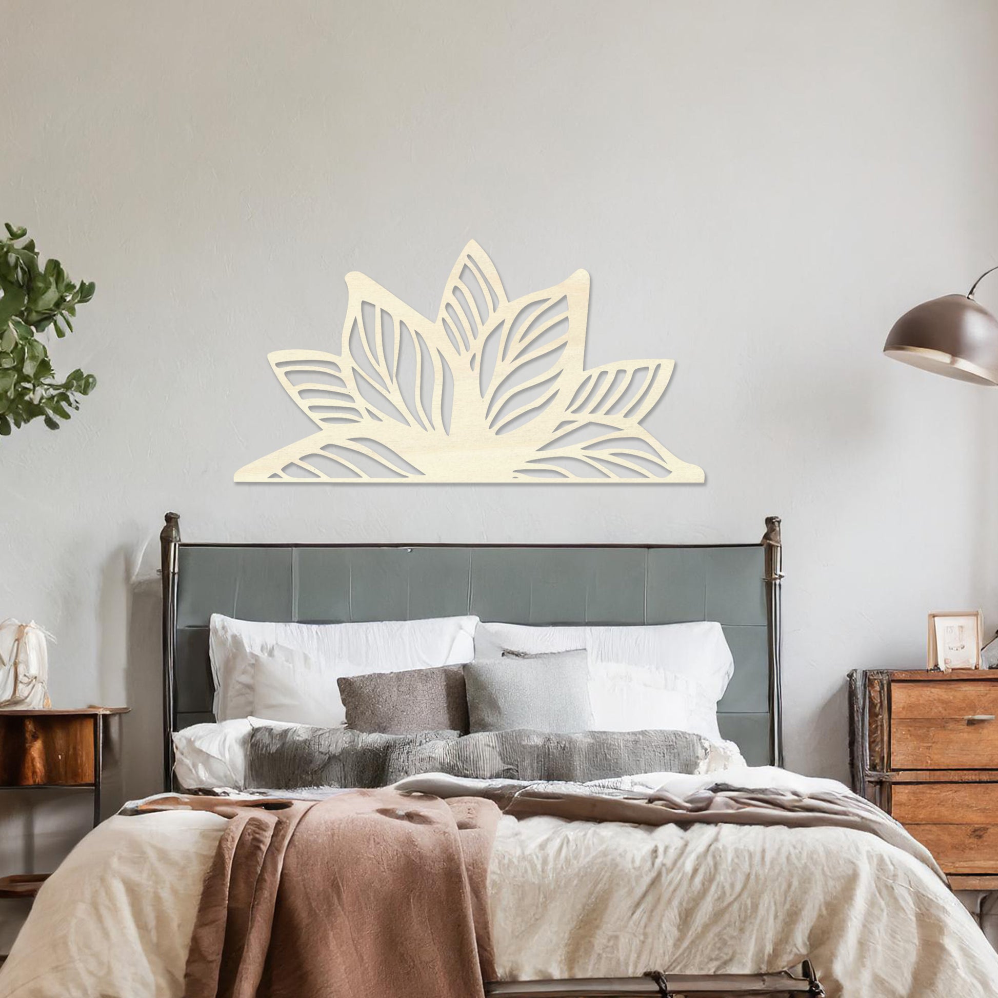 Wall art featuring a lotus-inspired design with layered leaves and intricate cut-out patterns. The piece is displayed on a neutral wall within modern decor, adding a natural and calming focal point to the space.