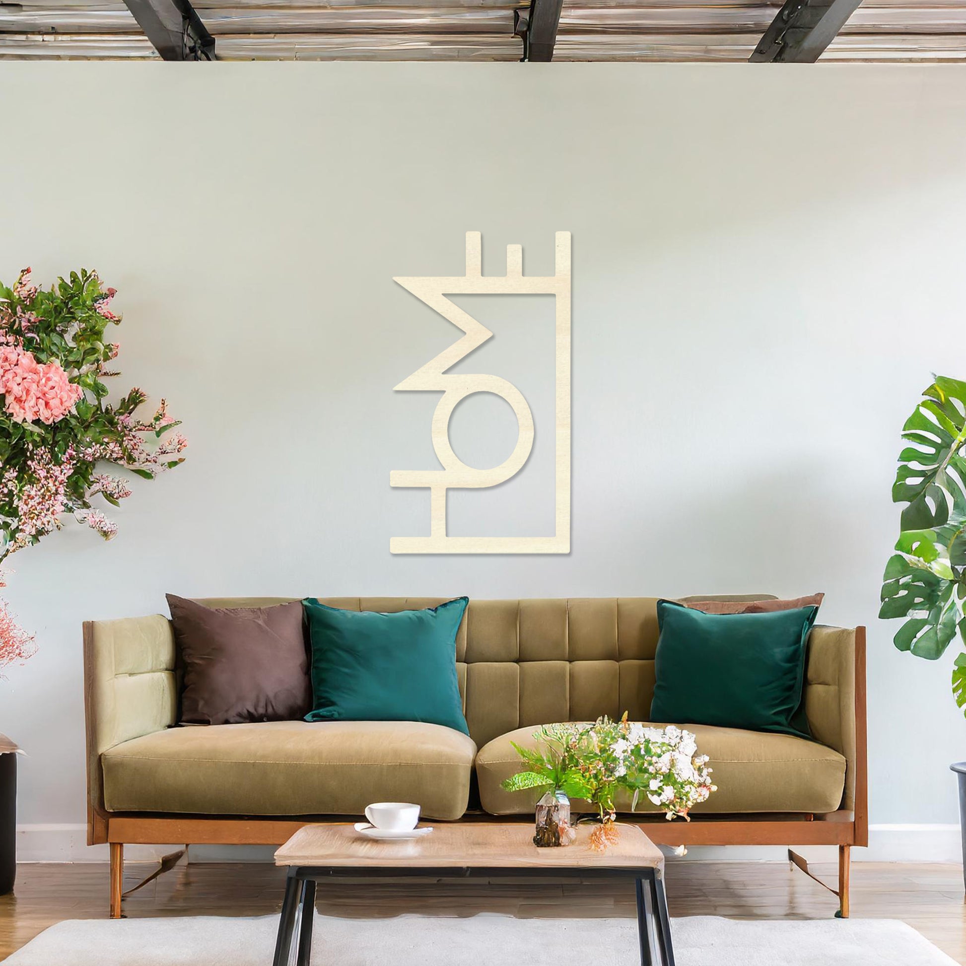 Wall art featuring the word "HOME" in a bold, modern design with geometric shapes integrated into the lettering. The piece is displayed on a neutral wall within contemporary room decor, adding a stylish and welcoming touch to the space.