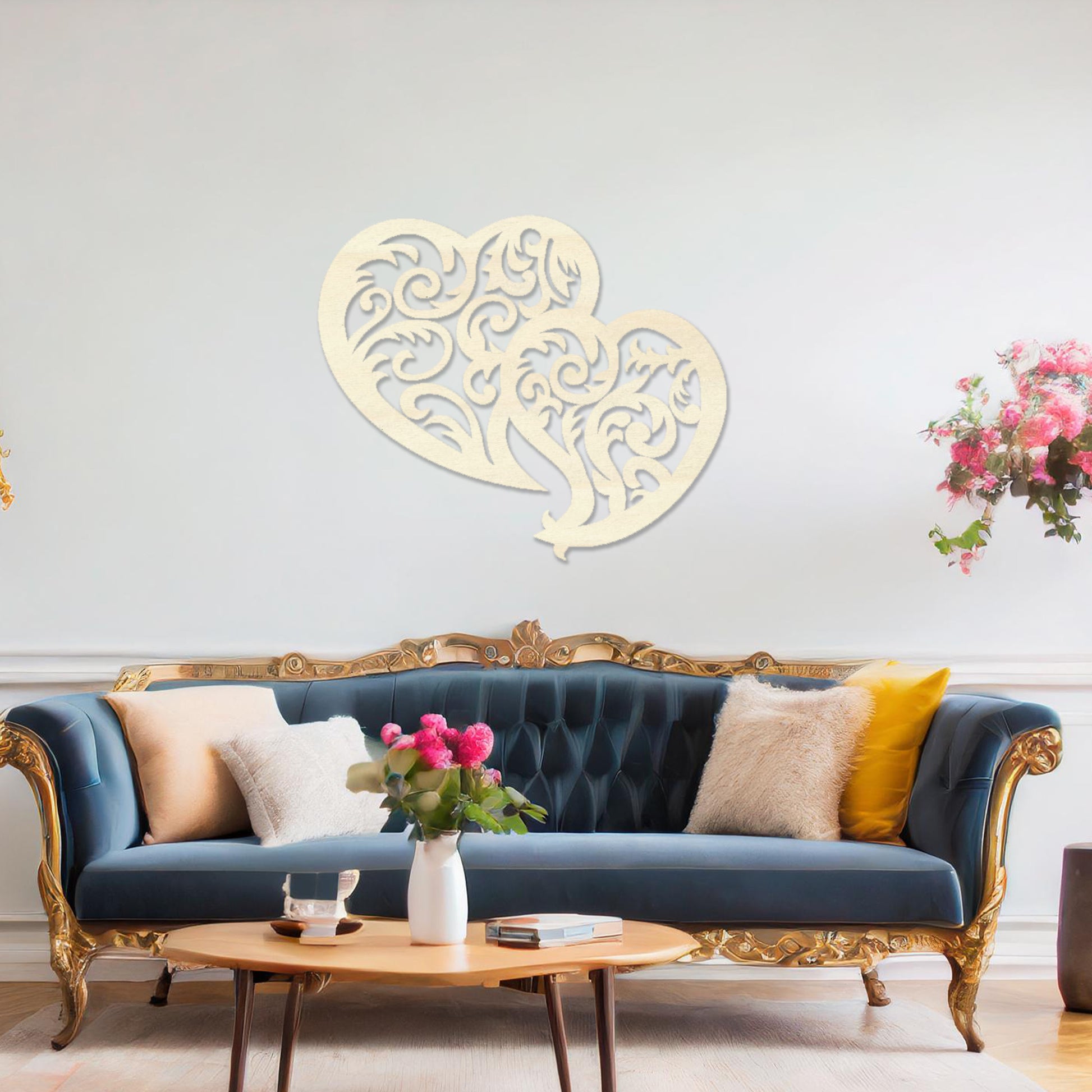 Wooden wall art design featuring two interlocking hearts with intricate swirling patterns, placed on a neutral wall within modern room decor. The design combines elegance and romance with its flowing shapes and fine details.