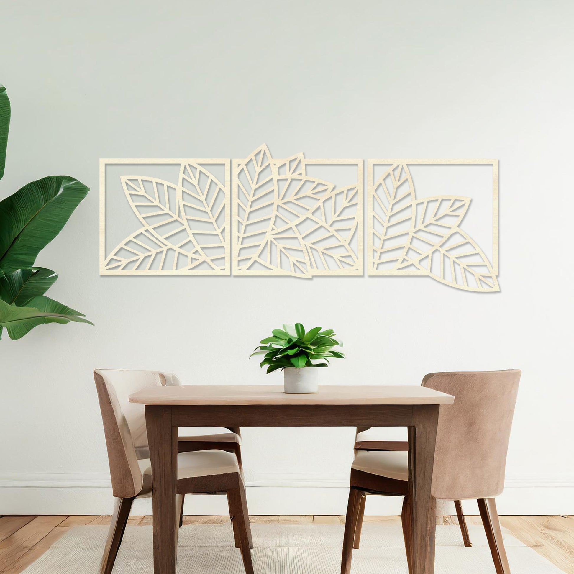 Wooden wall art featuring a three-panel design of overlapping leaf patterns with intricate cut-outs. The artwork is displayed on a neutral wall within modern room decor, highlighting its natural and elegant design.