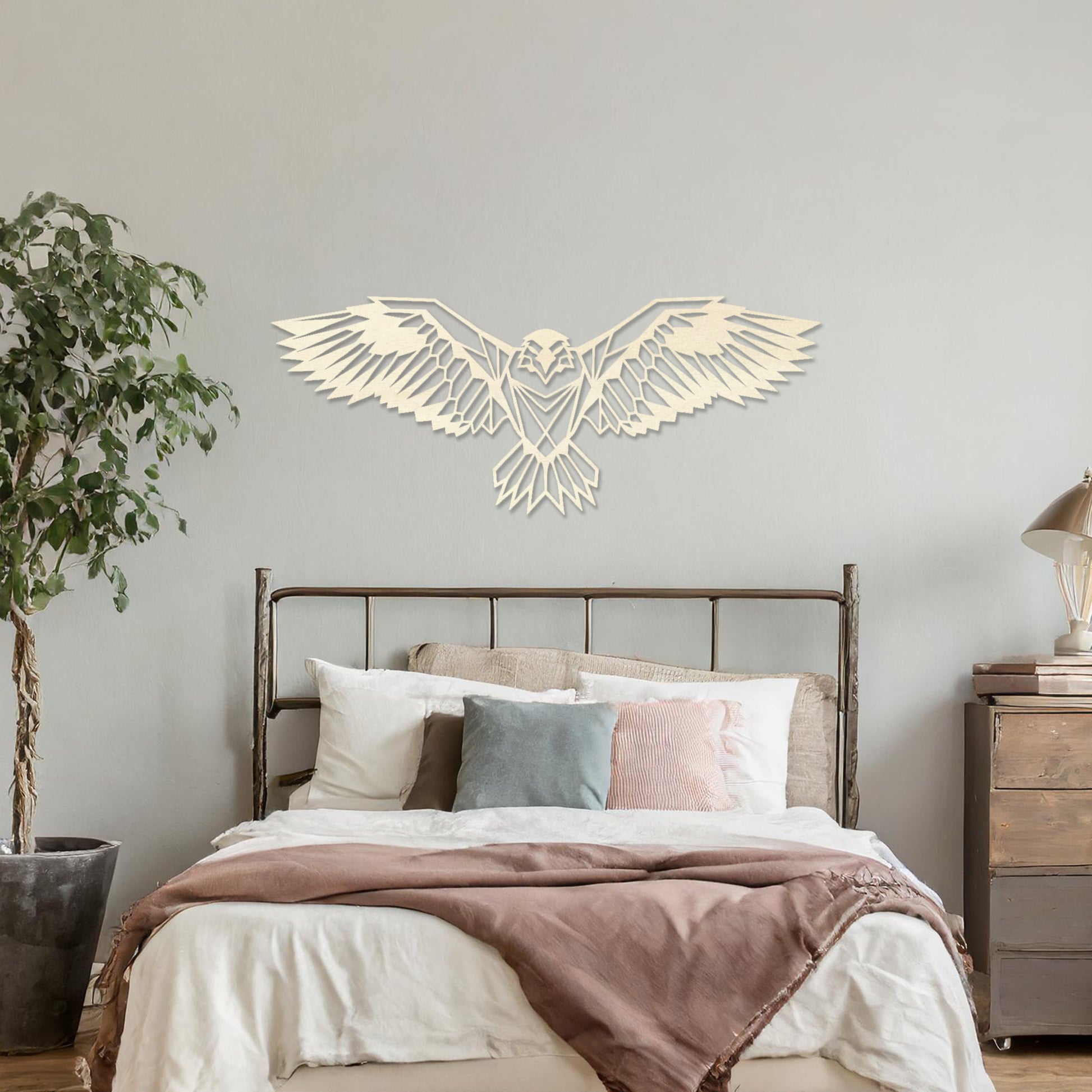 Wooden wall art showcasing a geometric eagle design with outstretched wings, displayed on a neutral wall within modern room decor, highlighting its bold and intricate craftsmanship.