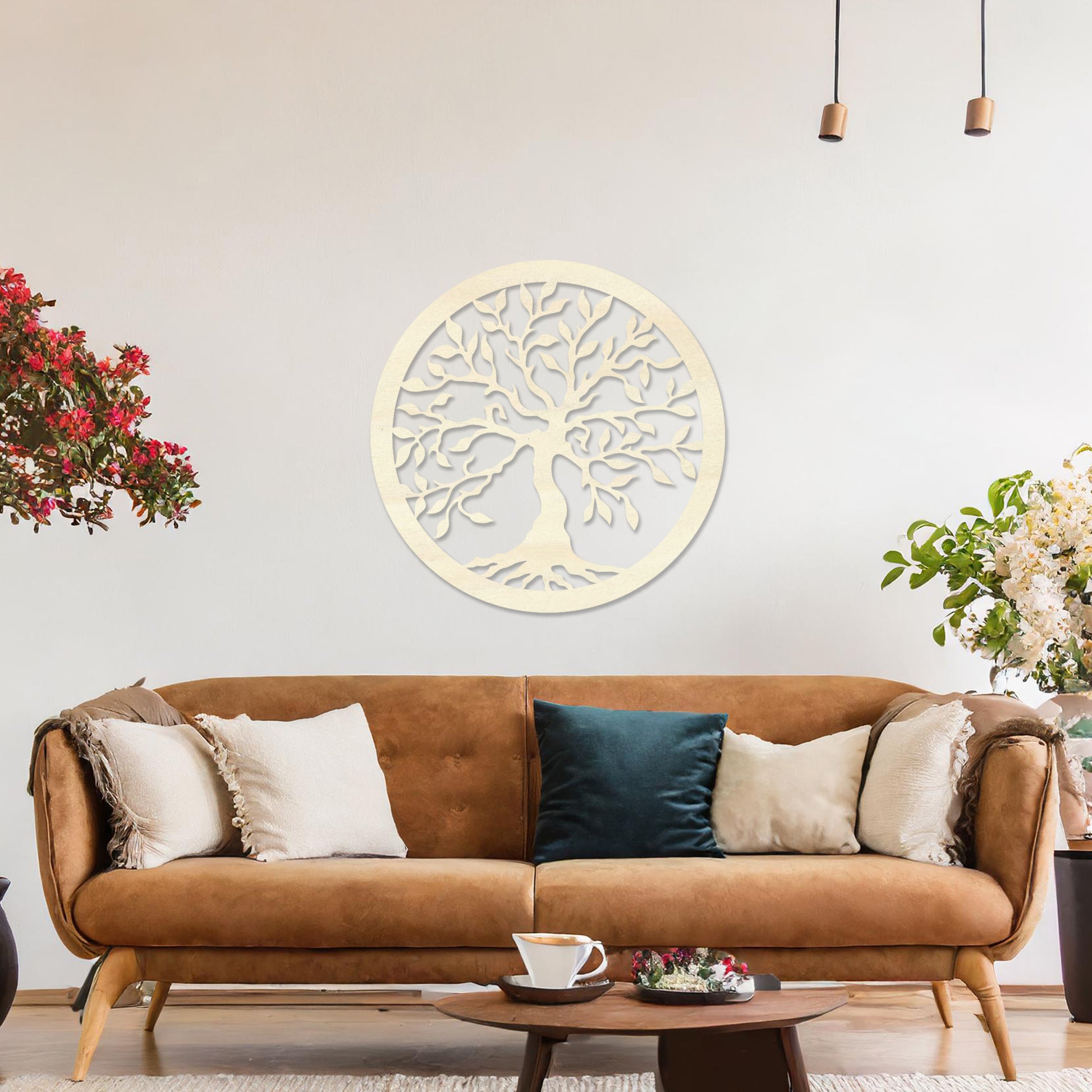 Round wooden wall art featuring an intricately designed tree with sprawling branches and delicate leaves, placed on a neutral wall within a modern setting. The art adds a natural and stylish focal point to the room.