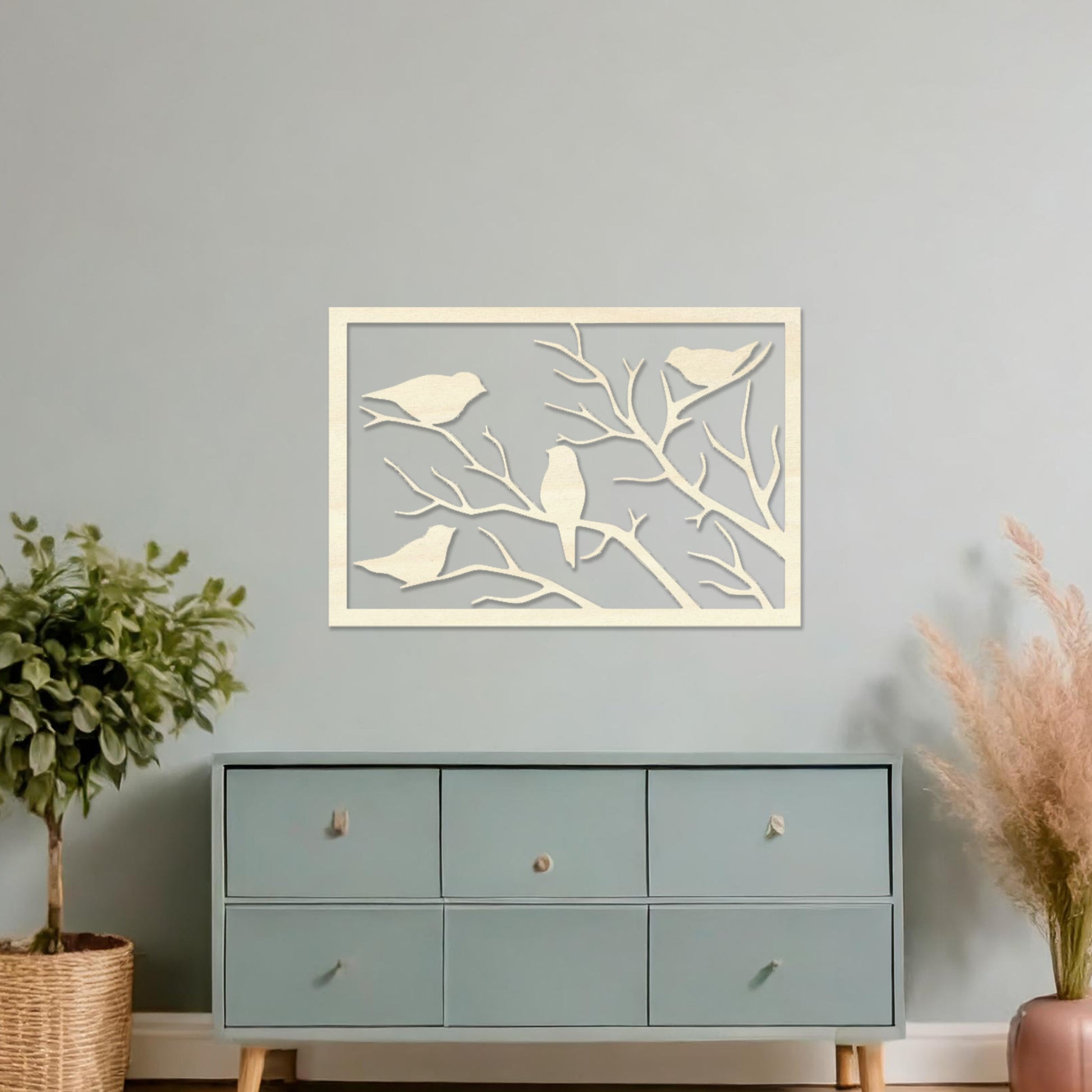 Wooden wall art featuring a rectangular design with birds perched on tree branches, displayed on a neutral wall within modern room decor, highlighting its elegant and nature-inspired craftsmanship.