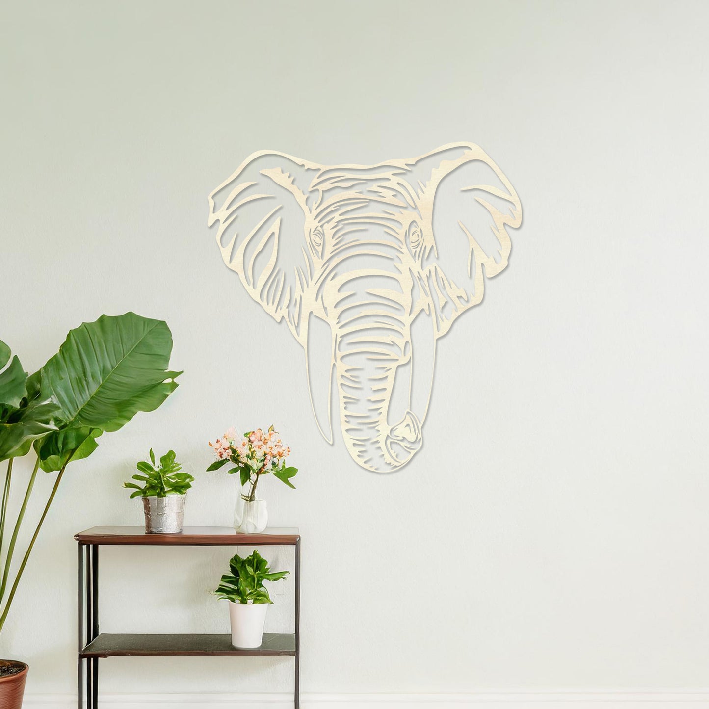Wooden wall art featuring an intricately detailed elephant head design, displayed on a neutral wall within modern room decor, highlighting its bold and artistic craftsmanship.