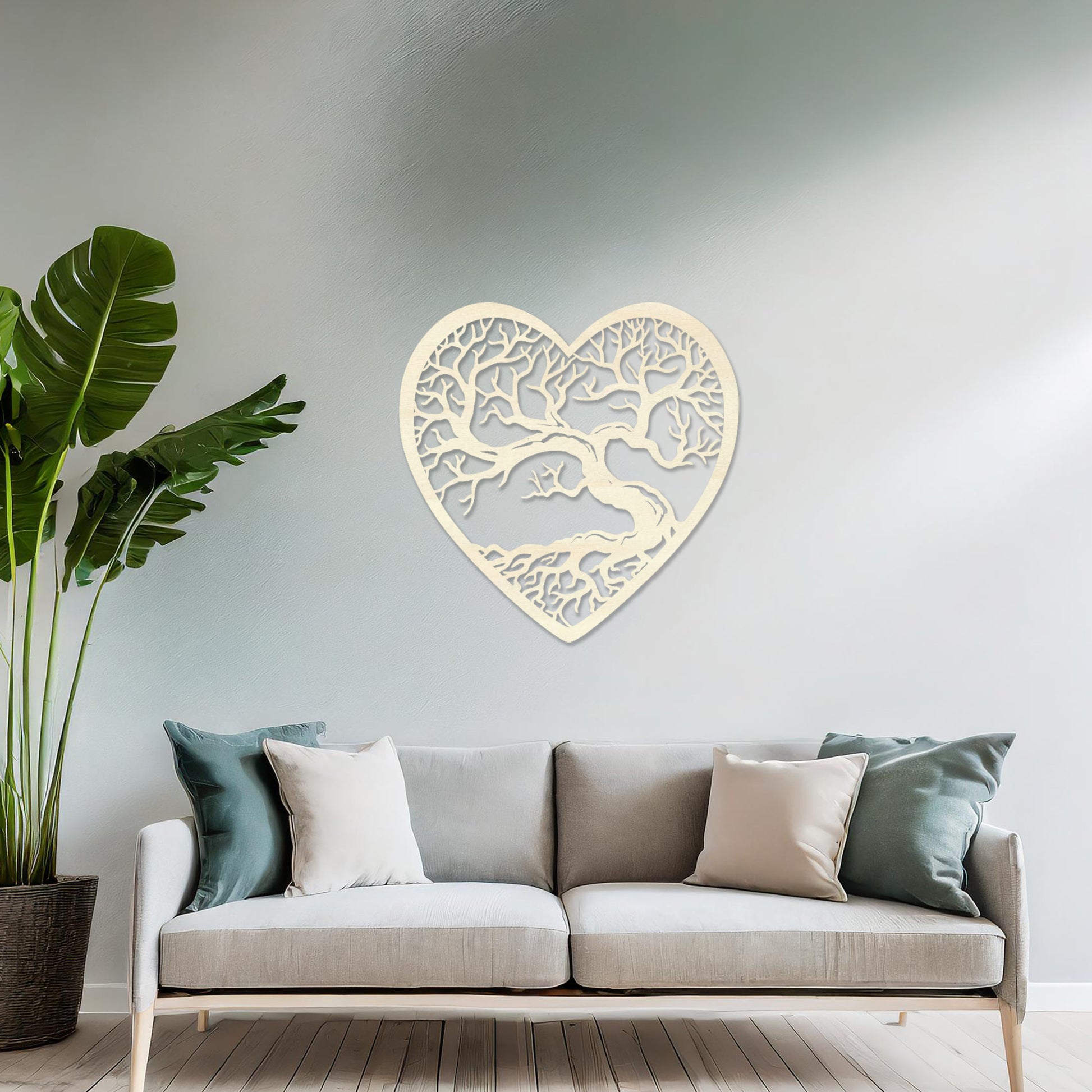 Wooden wall art featuring a heart-shaped design with an intricate tree and branching roots, displayed on a neutral wall within modern room decor, highlighting its natural and artistic craftsmanship.