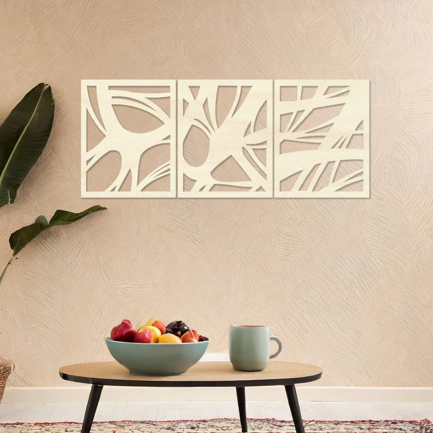 Wooden wall art design featuring a three-panel abstract composition with flowing, organic shapes and cutouts, placed on a neutral wall within modern room decor. The design blends dynamic movement and minimalism for a contemporary look.