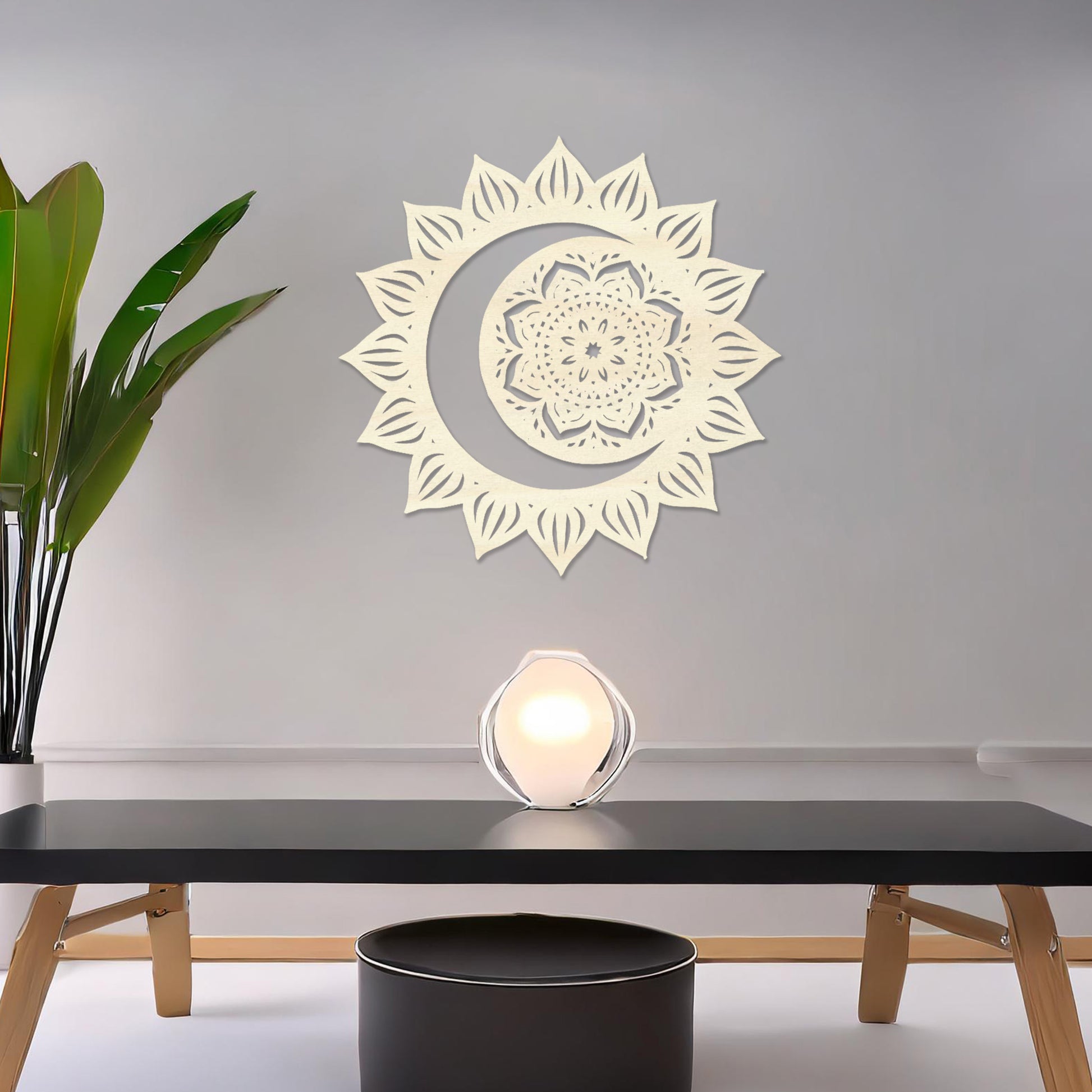 Wall art featuring a crescent moon surrounded by a mandala-inspired floral design with intricate details. The piece is displayed on a neutral wall within modern decor, adding a serene and decorative touch to the space.