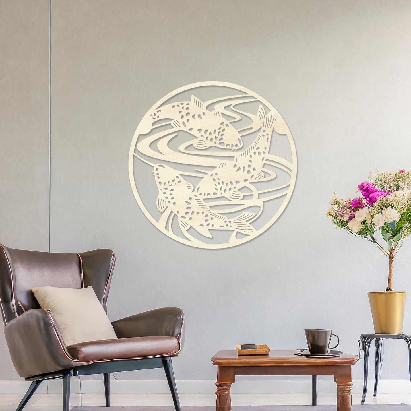 Wooden wall art design featuring koi fish swimming in circular patterns, framed in a round shape, placed on a neutral wall within modern room decor. The design evokes tranquility and movement with its elegant depiction of nature.