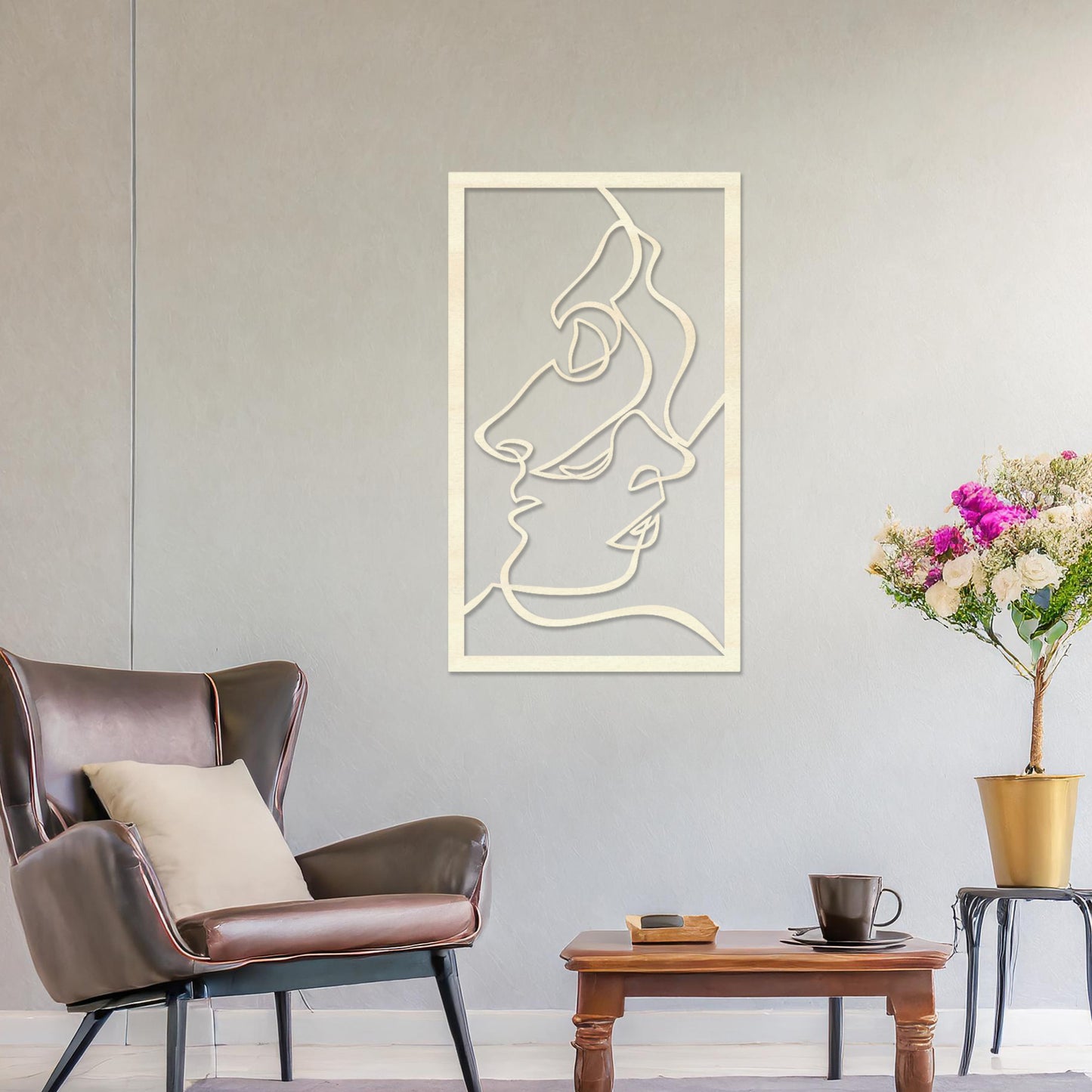 Wooden wall art design featuring abstract line art of two faces, placed on a neutral wall with modern room decor. The design is minimalistic and elegant, capturing human forms through flowing lines.