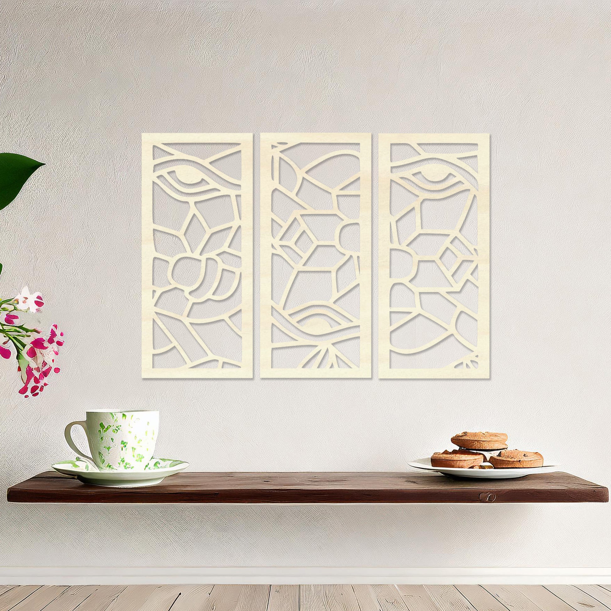 Wooden wall art featuring a three-panel abstract design with geometric shapes and eye motifs. The artwork is displayed on a neutral wall within modern room decor, showcasing its intricate and unique pattern.
