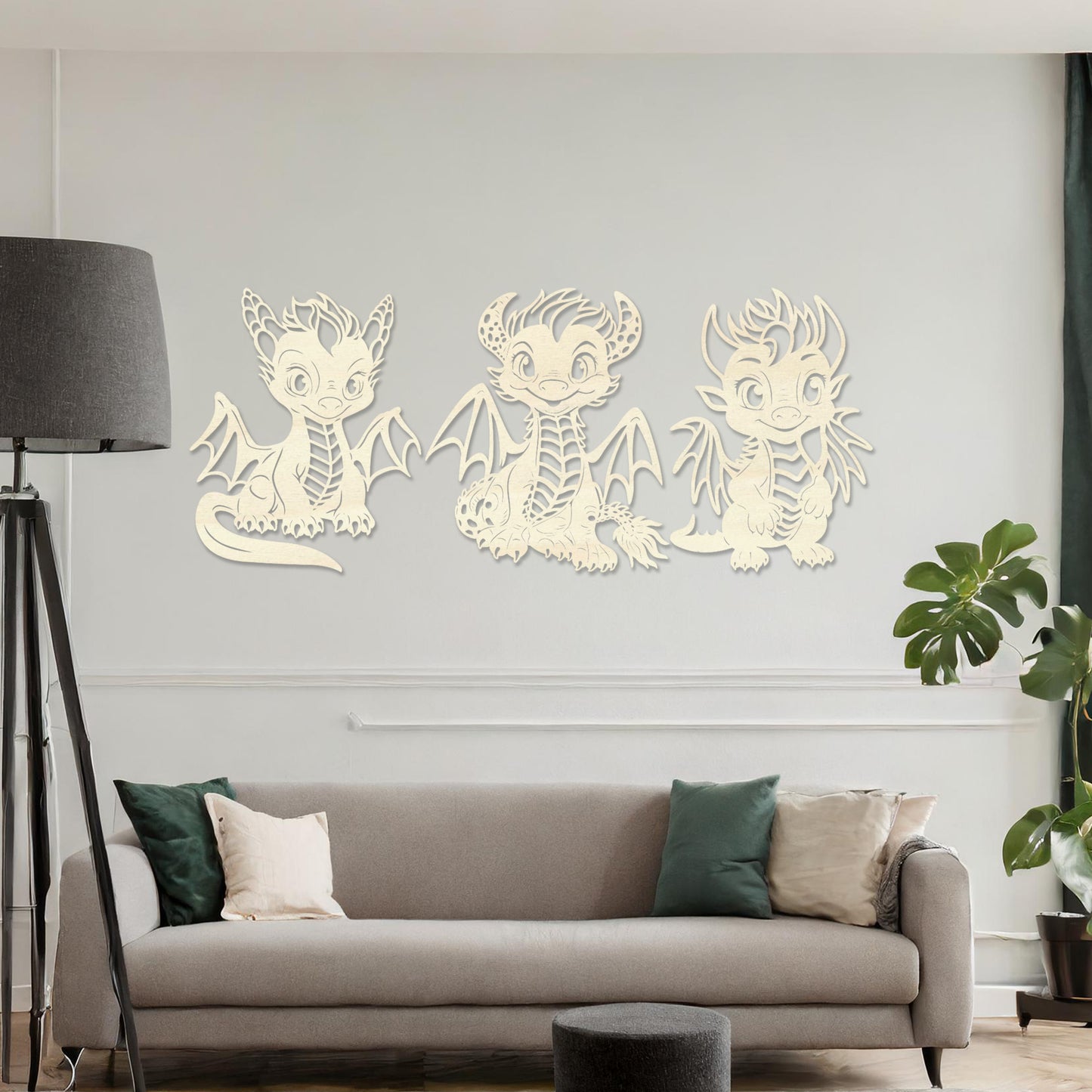 Wooden wall art design featuring three playful dragon characters, each with different poses and expressions, placed on a neutral wall within modern room decor. The design brings whimsy and charm with detailed features and lively energy.