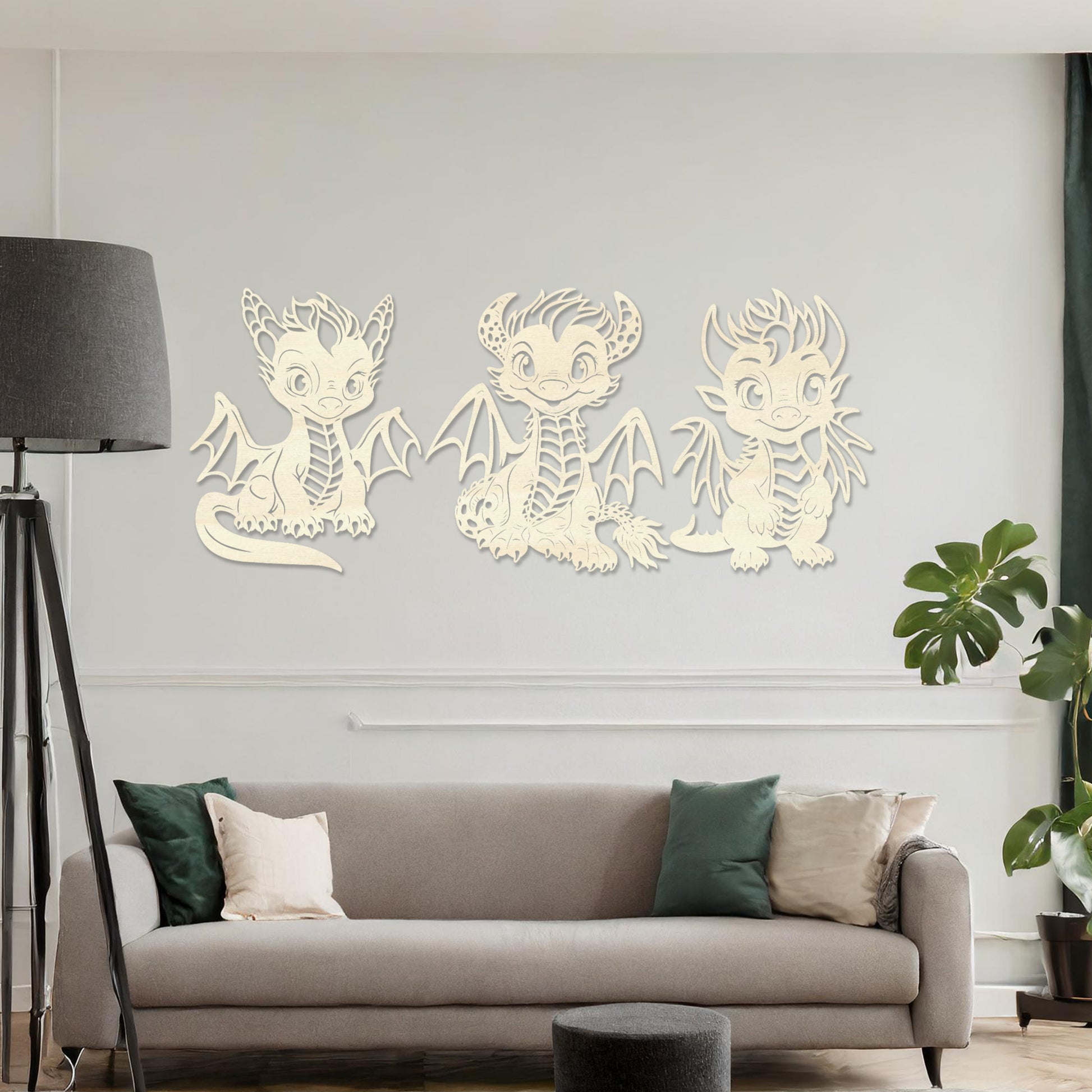 Wooden wall art design featuring three playful dragon characters, each with different poses and expressions, placed on a neutral wall within modern room decor. The design brings whimsy and charm with detailed features and lively energy.