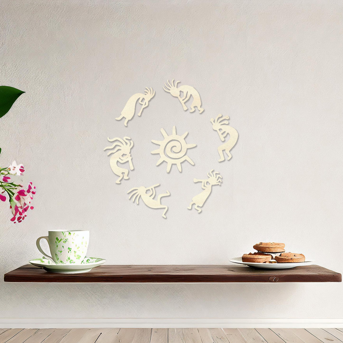 Wooden wall art featuring a circular arrangement of dancing figures surrounding a central sun design. The artwork is displayed on a neutral wall within modern room decor, highlighting its tribal and artistic charm.