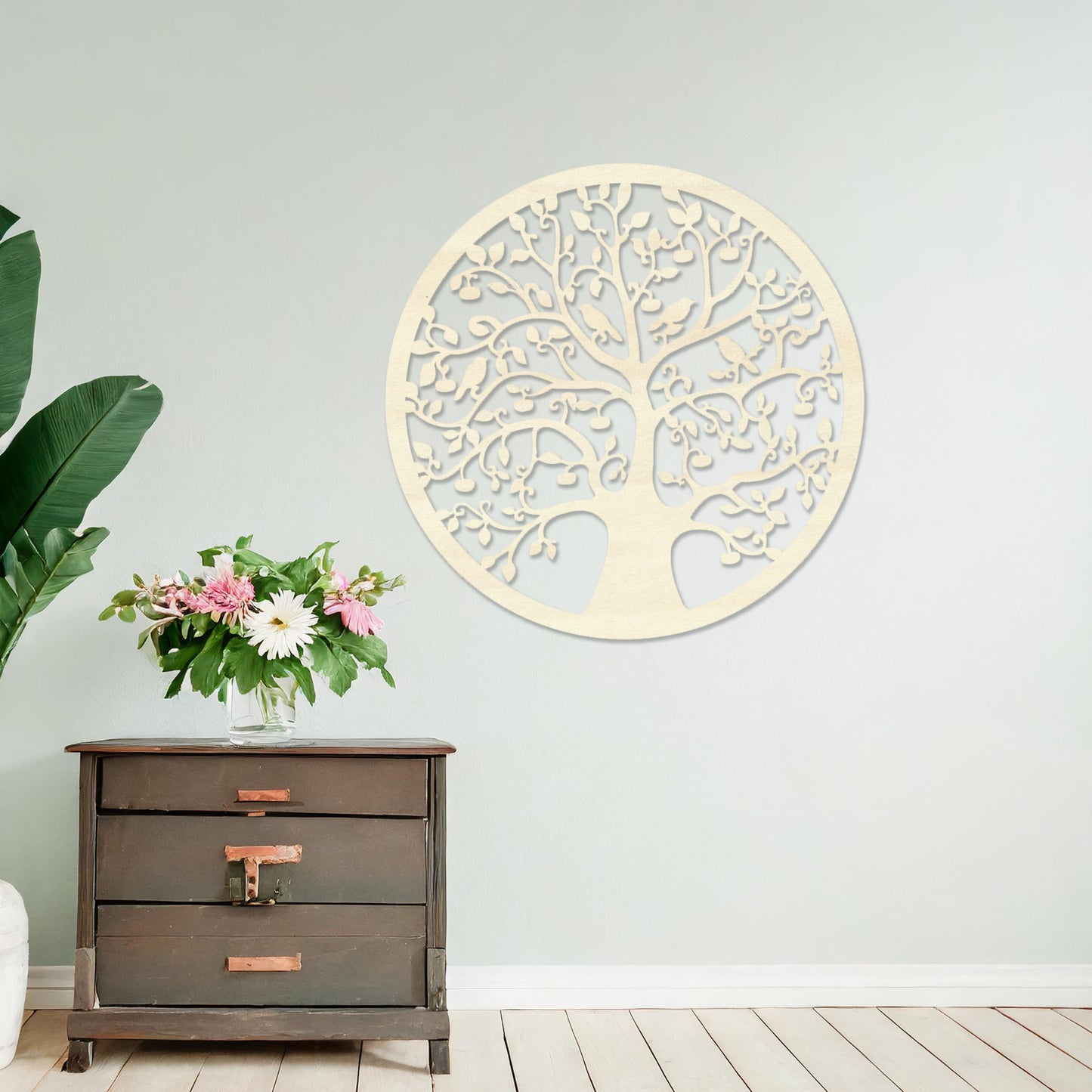 Wooden wall art featuring a circular tree design with intricate branches, leaves, and birds, displayed on a neutral wall within modern room decor, highlighting its detailed and nature-inspired craftsmanship.