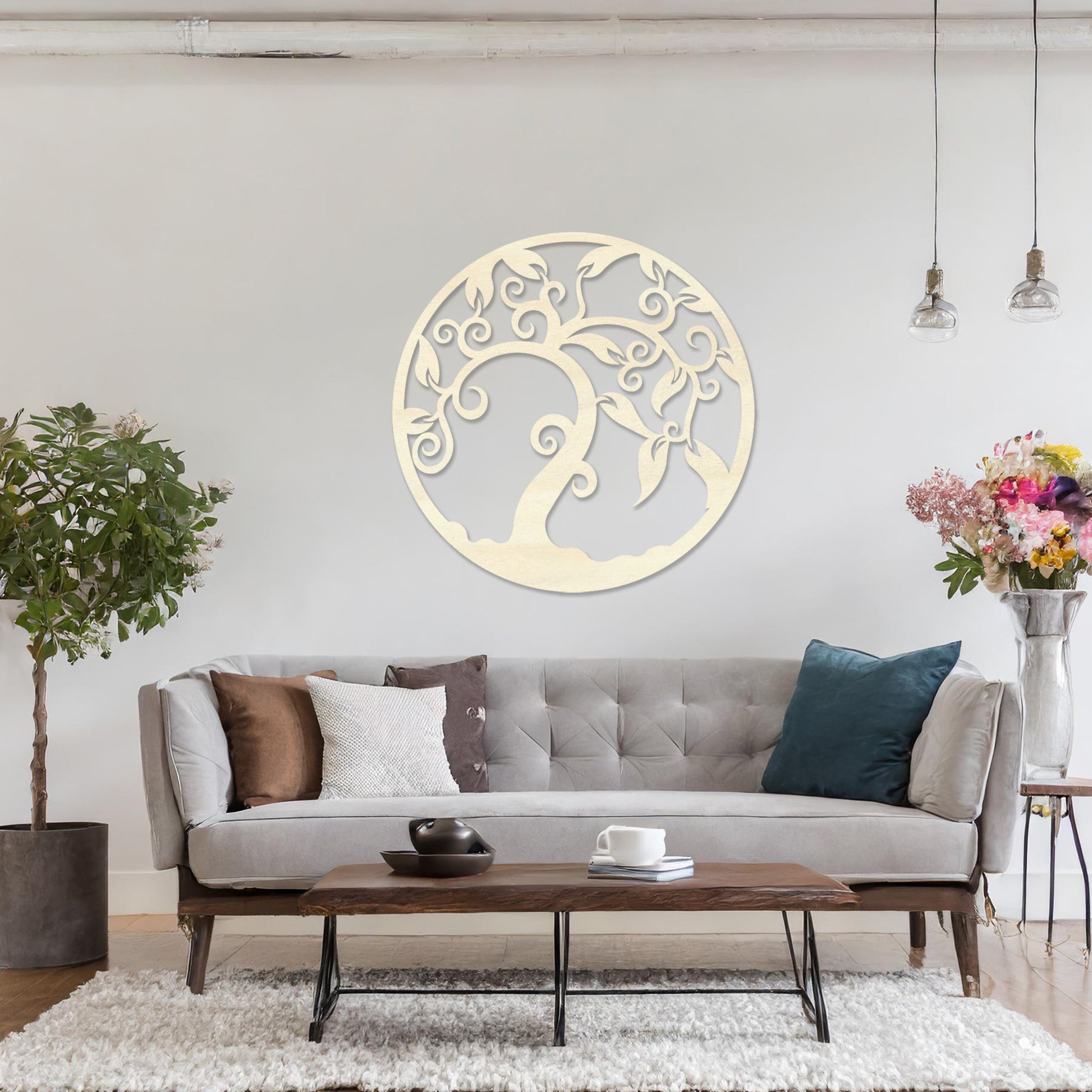 Wooden wall art design featuring a swirling tree with curved branches and leaves, framed in a circular shape, placed on a neutral wall within modern room decor. The design highlights elegant, flowing forms for a peaceful, organic look.