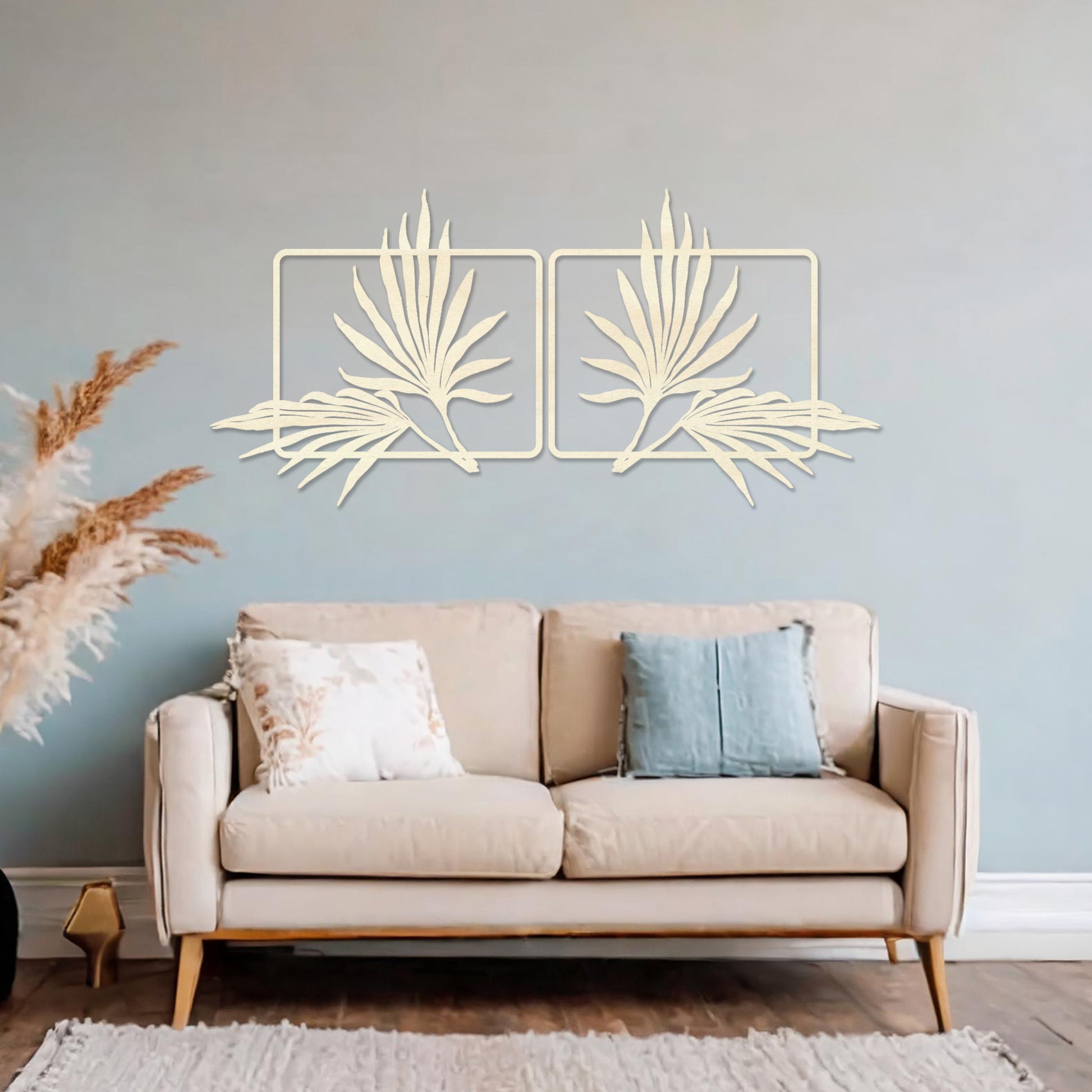 Wooden wall art featuring two symmetrical palm leaf designs within rectangular frames. The artwork is placed on a neutral wall in modern room decor, showcasing its elegant natural motif.