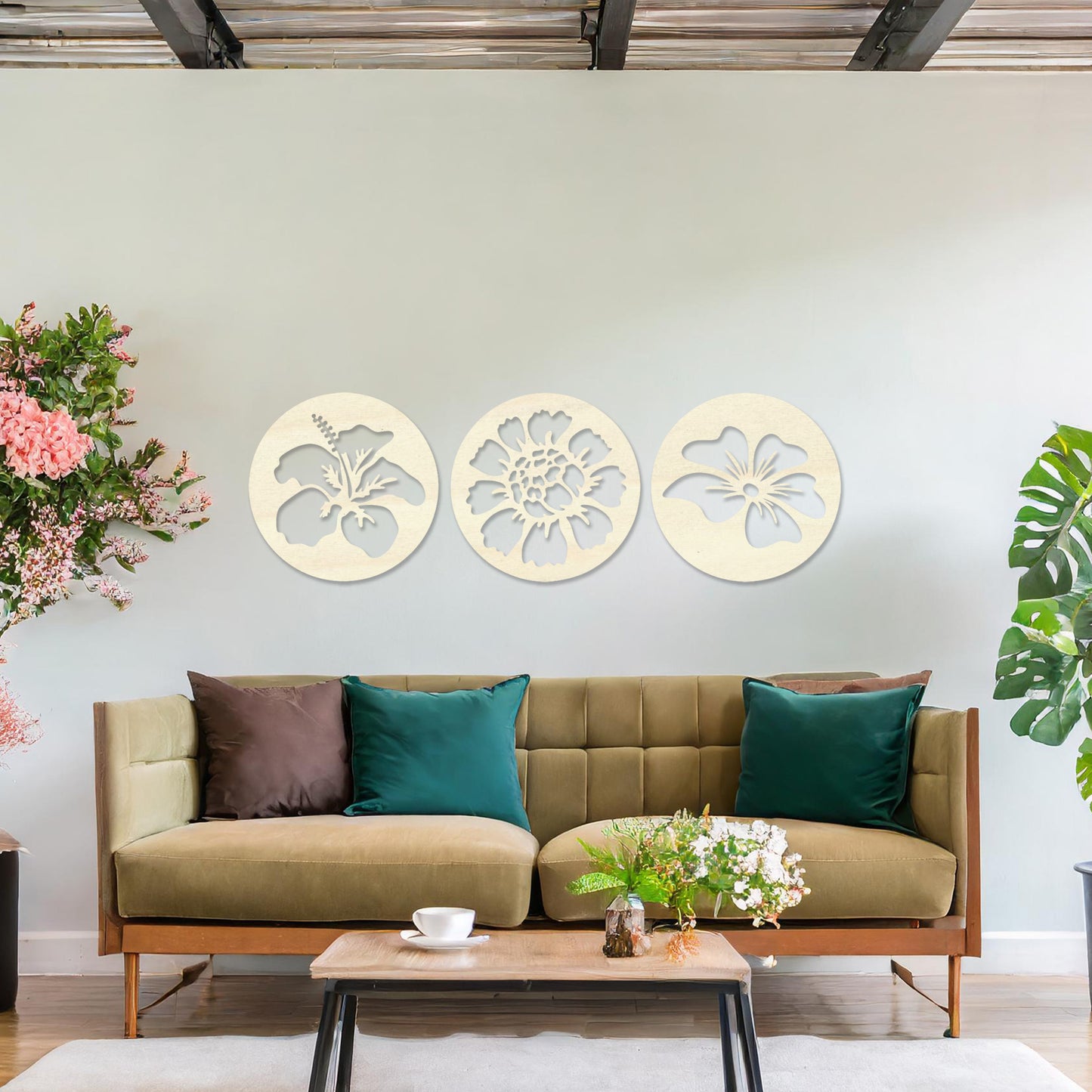 Wall art featuring a set of three circular panels, each showcasing a distinct floral design with intricate cut-out details. The artwork is displayed on a neutral wall within modern decor, adding a charming and decorative touch to the space.