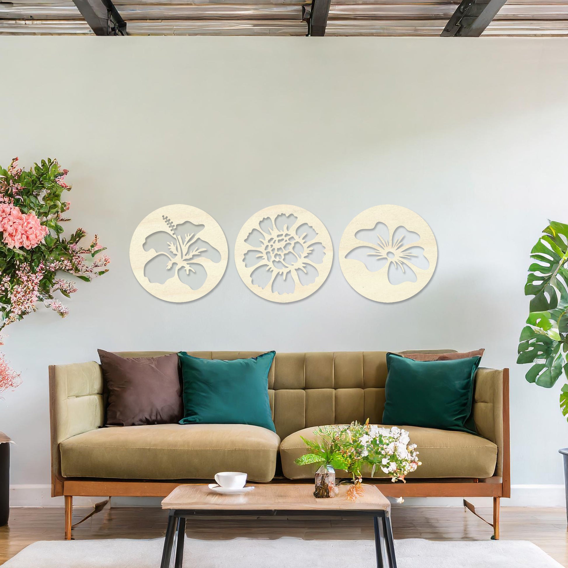 Wall art featuring a set of three circular panels, each showcasing a distinct floral design with intricate cut-out details. The artwork is displayed on a neutral wall within modern decor, adding a charming and decorative touch to the space.