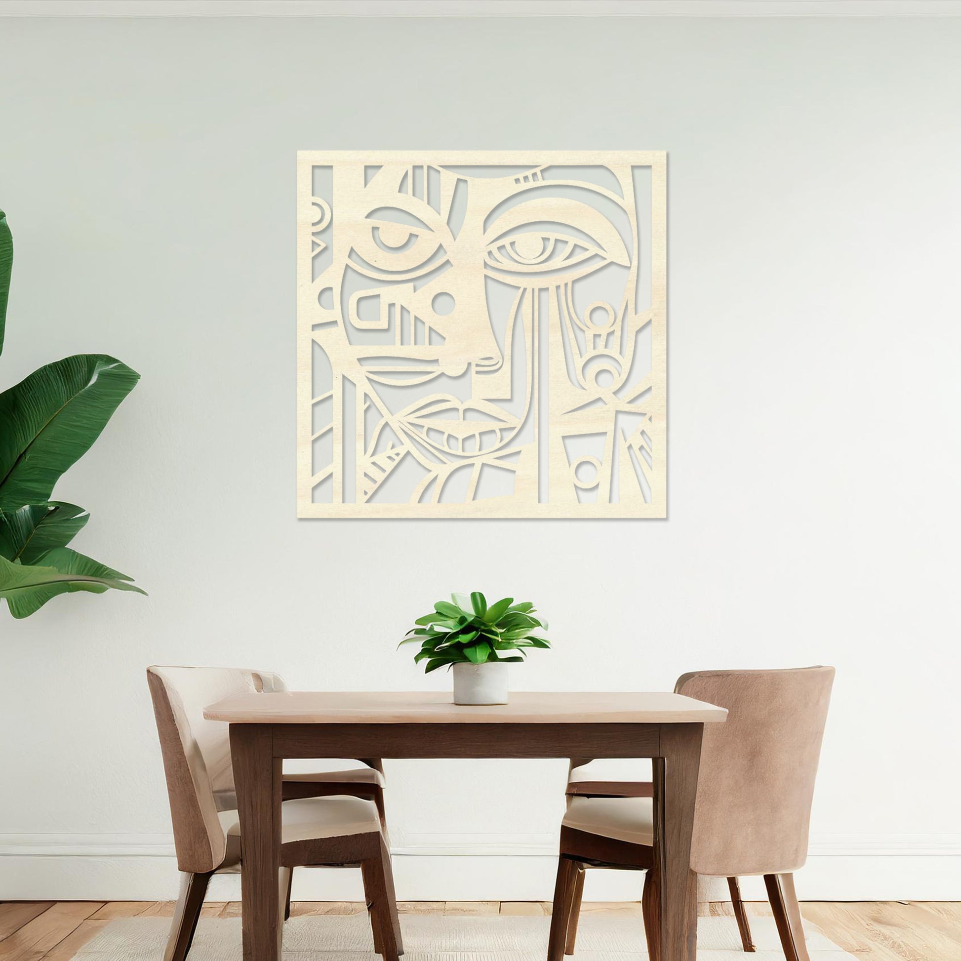 Wall art featuring an abstract face design with geometric patterns and intricate details, creating a modern and artistic composition. The piece is displayed on a neutral wall within rustic-modern decor, adding a bold and expressive focal point to the space.