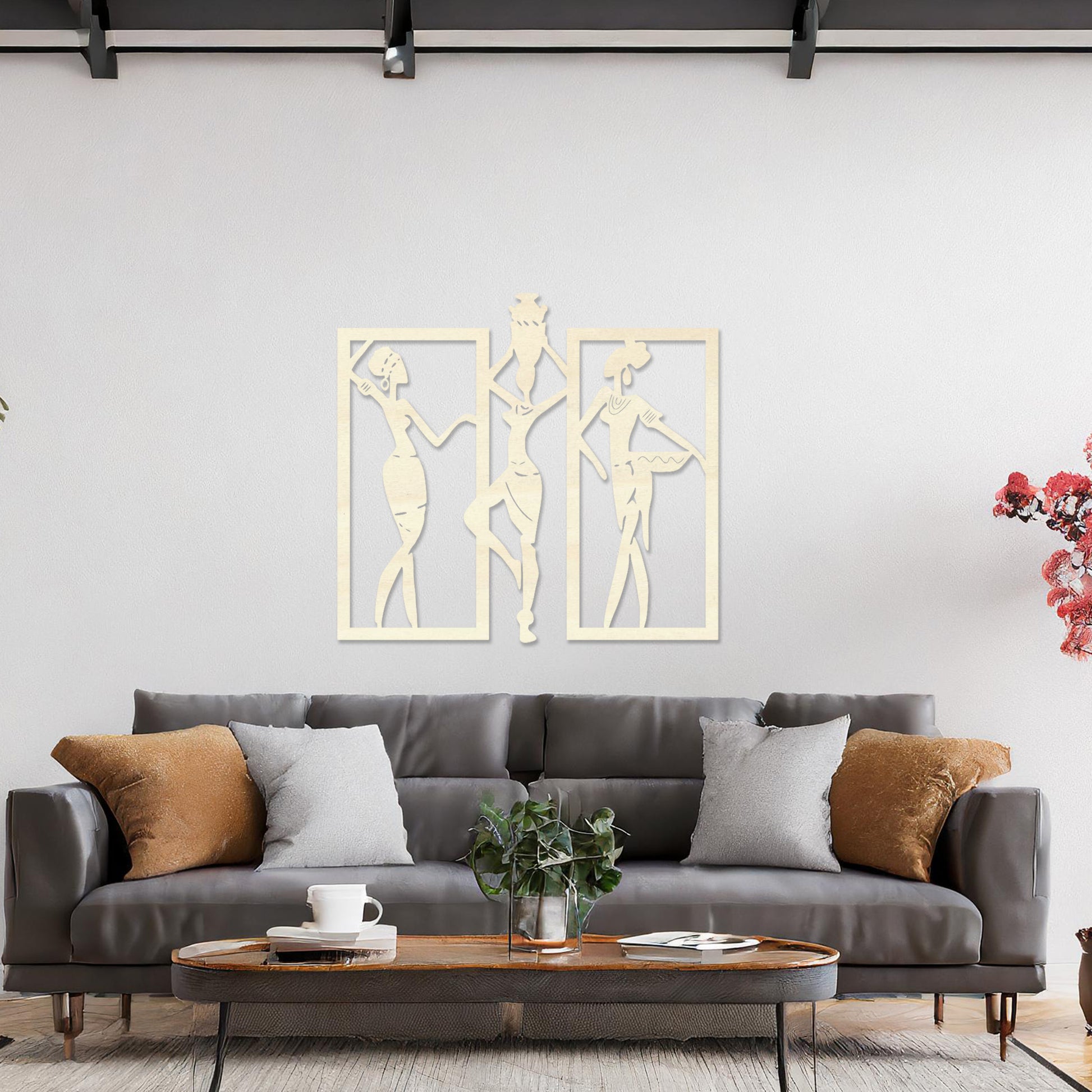 Wall art featuring a triptych design of abstract figures in dynamic poses, framed within rectangular panels. The artwork is displayed on a neutral wall within modern decor, adding an artistic and cultural touch to the space.