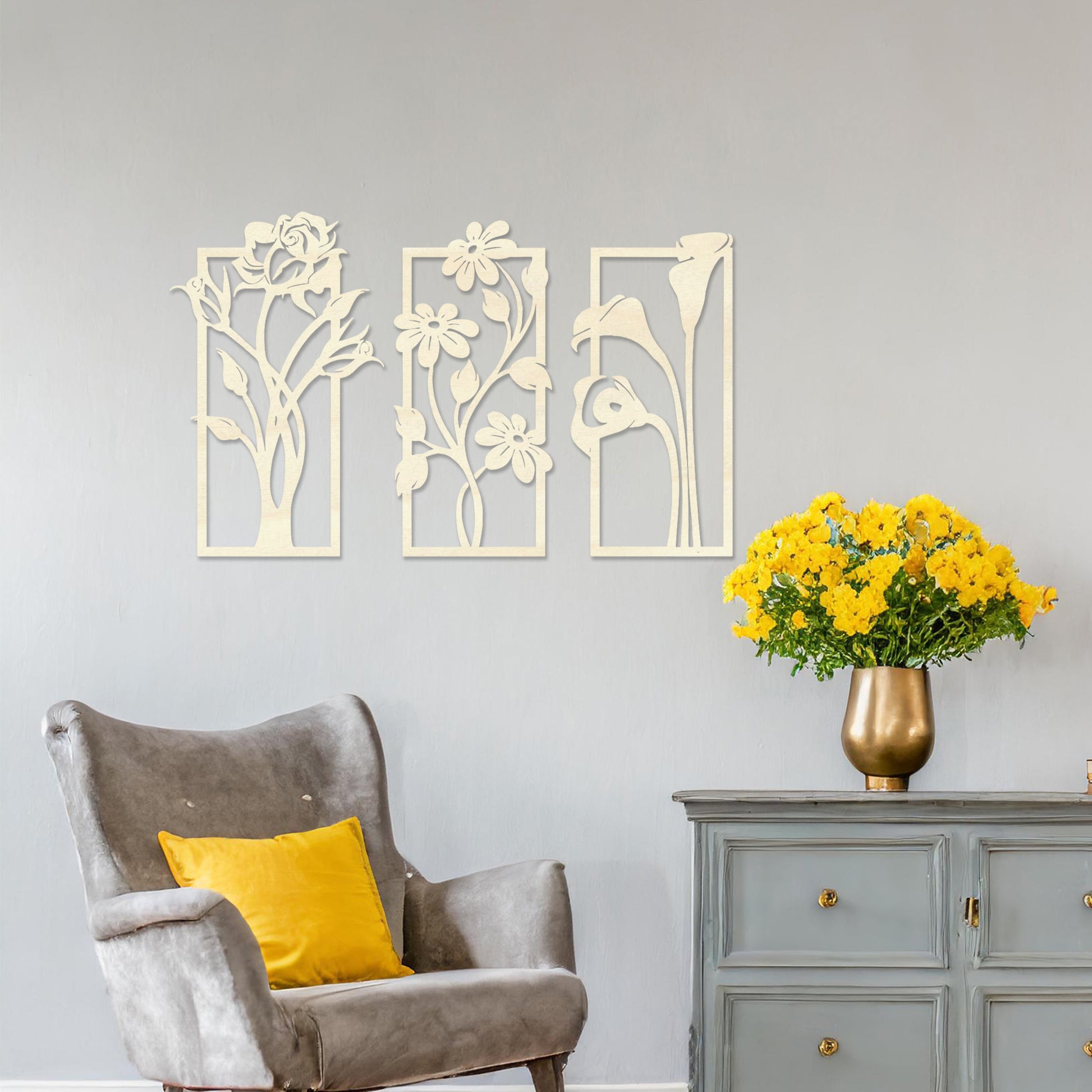 Wall art featuring a triptych of floral designs, each panel showcasing distinct flowers such as roses, daisies, and calla lilies. The artwork is displayed on a neutral wall within modern decor, adding a natural and elegant touch to the space.
