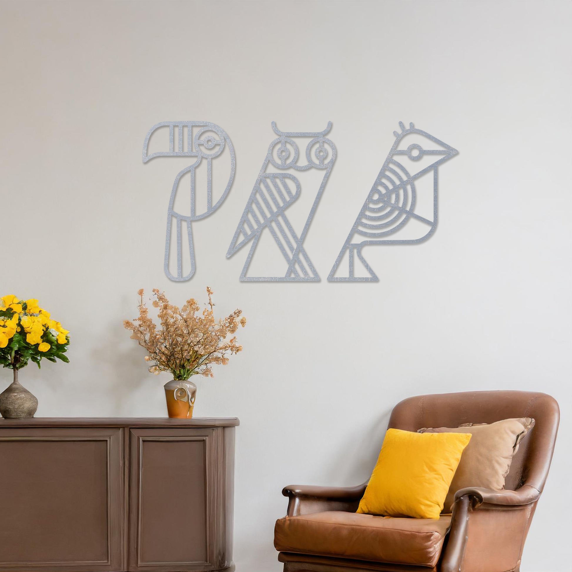 Wooden wall art featuring a trio of abstract geometric bird designs, including a toucan, an owl, and a sparrow. The artwork is displayed on a neutral wall within modern room decor, showcasing its playful and artistic charm.