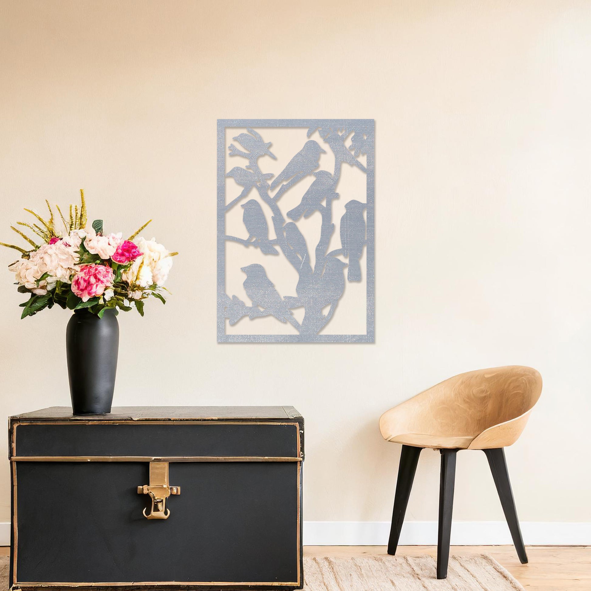 Wooden wall art featuring a detailed design of birds perched on branches. The artwork is displayed on a neutral wall within modern room decor, highlighting the intricate natural pattern.