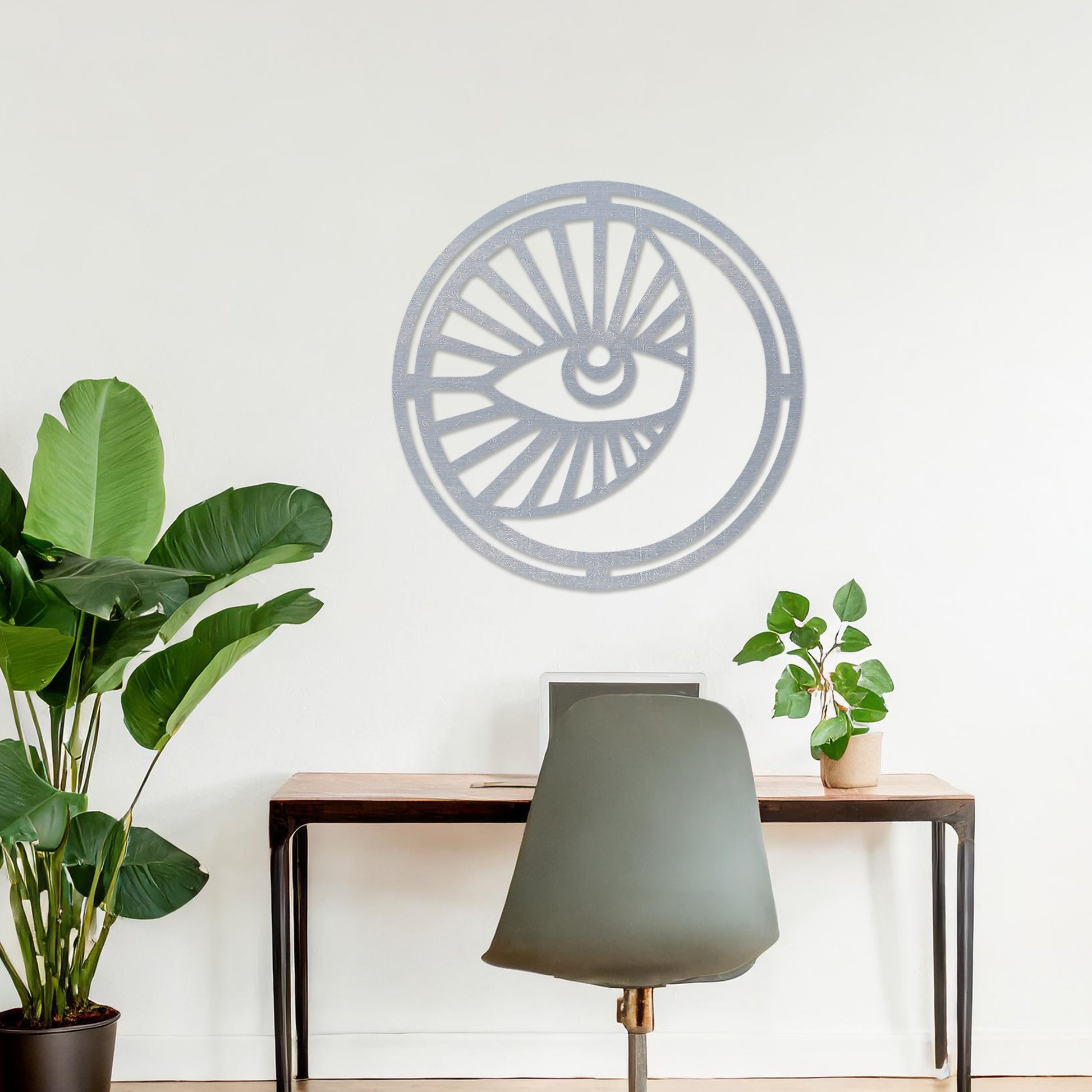 Wooden wall art featuring a circular design with an eye motif and geometric patterns radiating outward. The artwork is displayed on a neutral wall within modern room decor, highlighting its bold and contemporary aesthetic.
