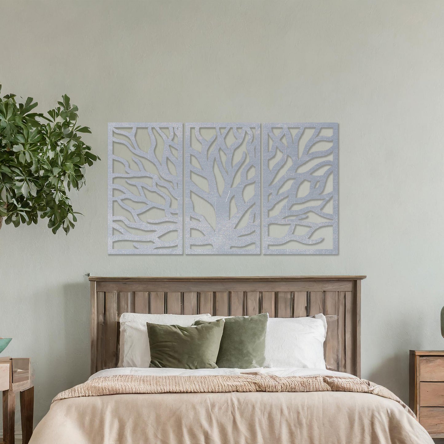 Wooden wall art consisting of three panels featuring an abstract tree branch design, displayed on a neutral wall within modern room decor, emphasising its artistic and contemporary appeal.