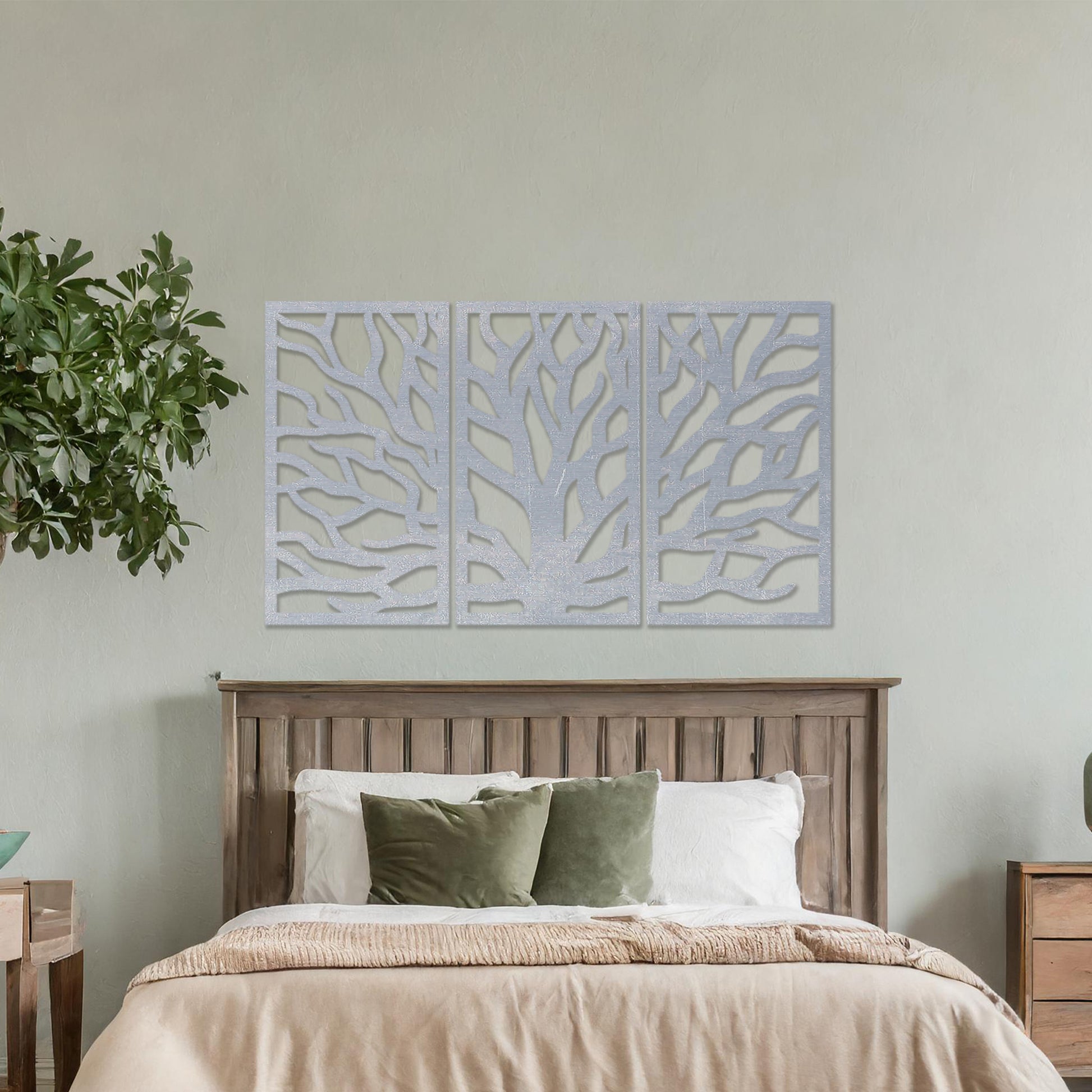 Wooden wall art consisting of three panels featuring an abstract tree branch design, displayed on a neutral wall within modern room decor, emphasising its artistic and contemporary appeal.