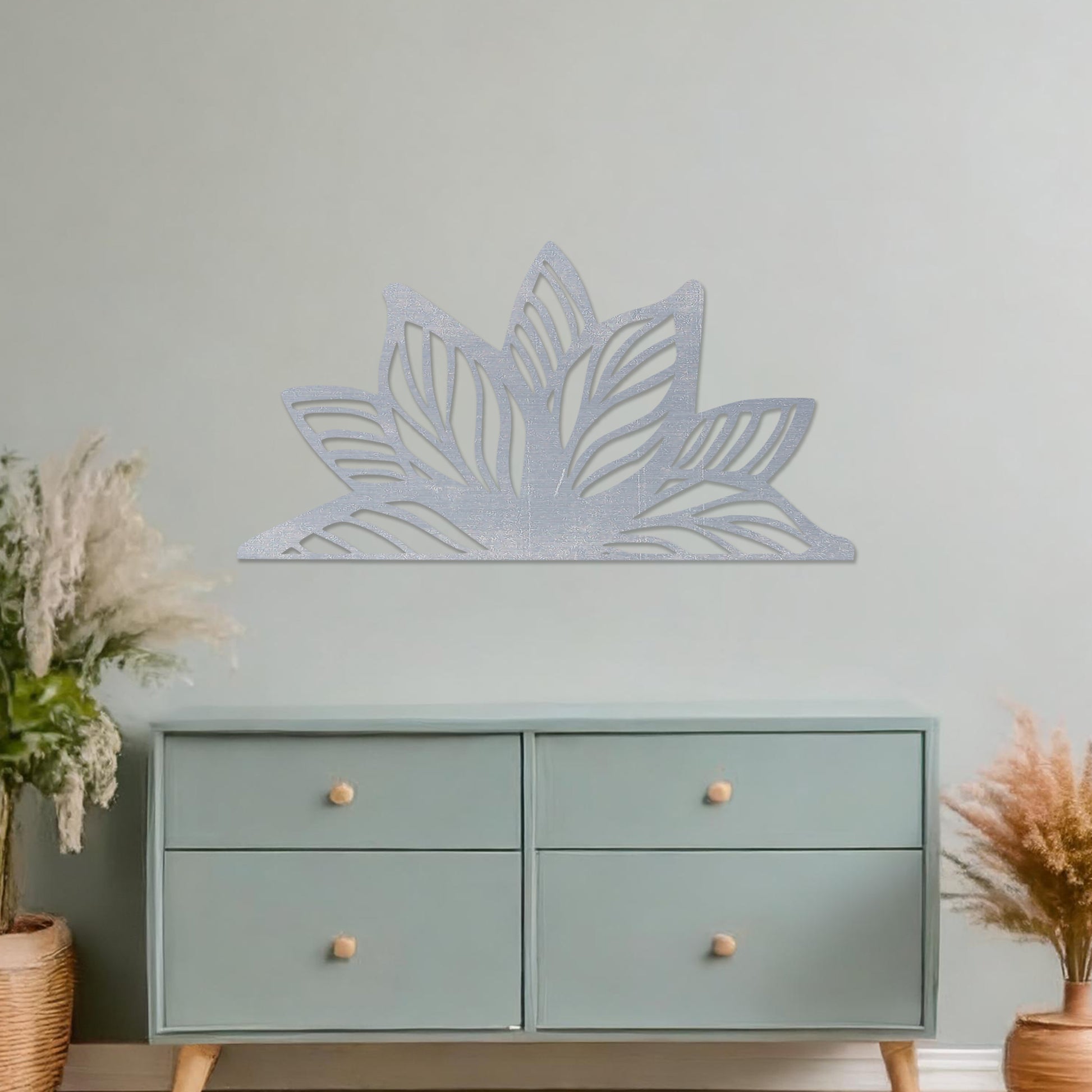Wall art featuring a lotus-inspired design with layered leaves and intricate cut-out patterns. The piece is displayed on a neutral wall within modern decor, adding a natural and calming focal point to the space.