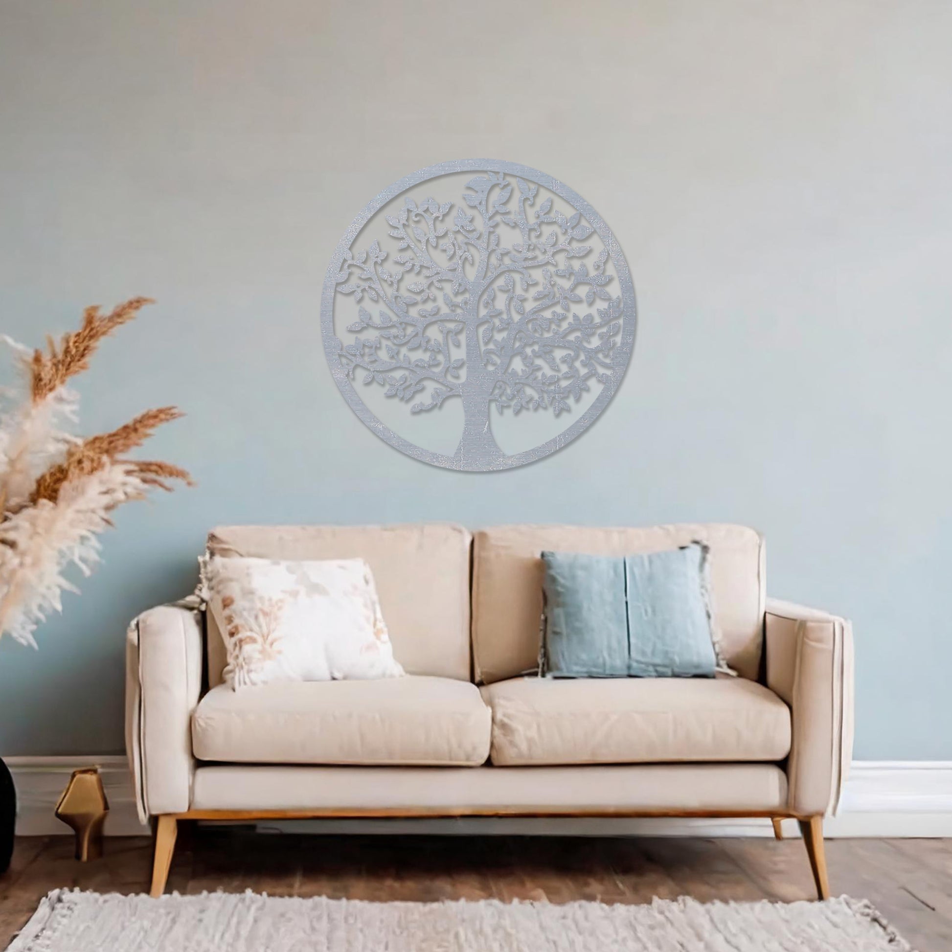 Wooden wall art featuring a circular design with an intricately detailed tree of life motif. The artwork is displayed on a neutral wall within modern room decor, highlighting its symbolic and artistic appeal.