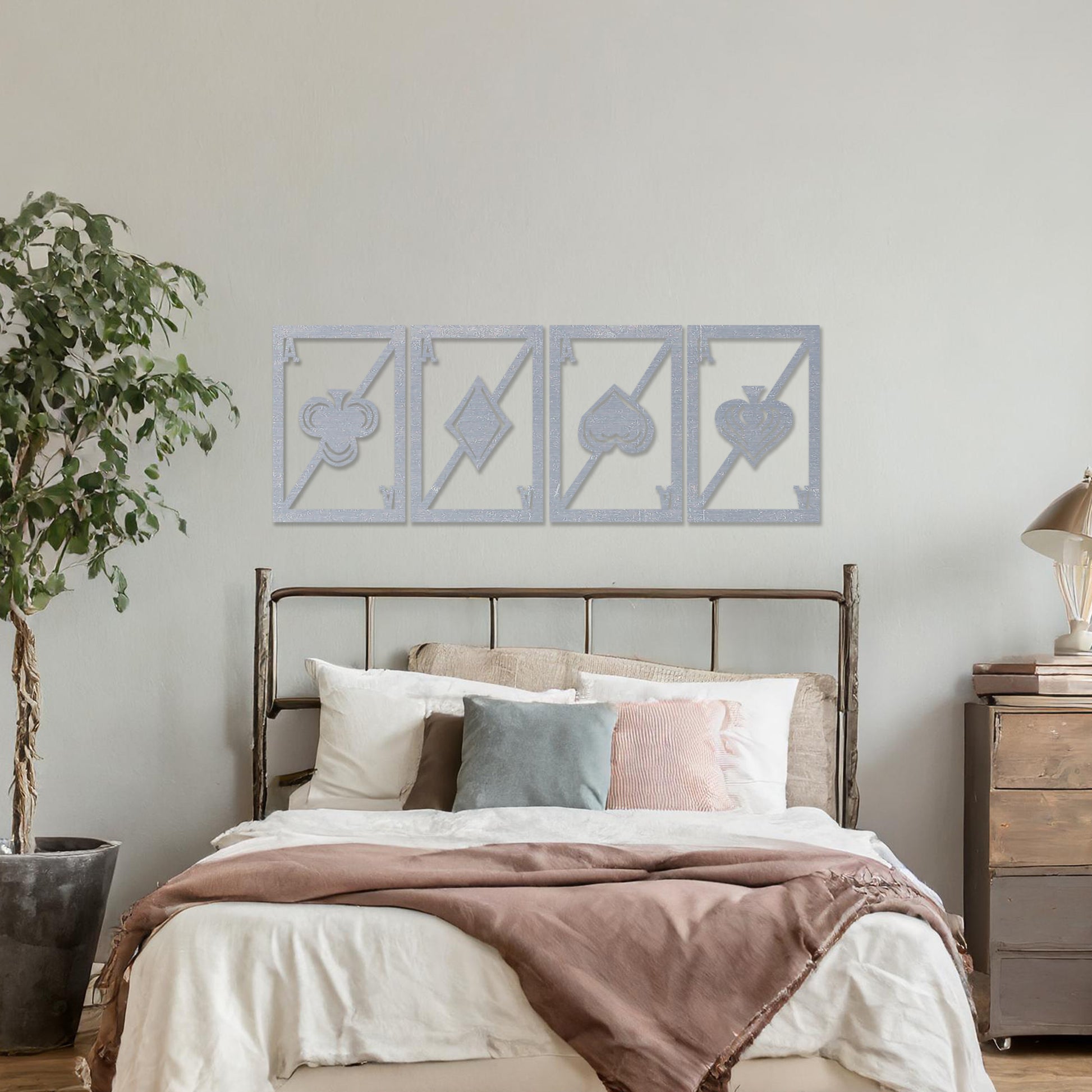 Wooden wall art featuring a set of four panels with playing card ace designs, each showcasing a club, diamond, heart, and spade symbol, displayed on a neutral wall within modern room decor, highlighting its bold and creative craftsmanship.