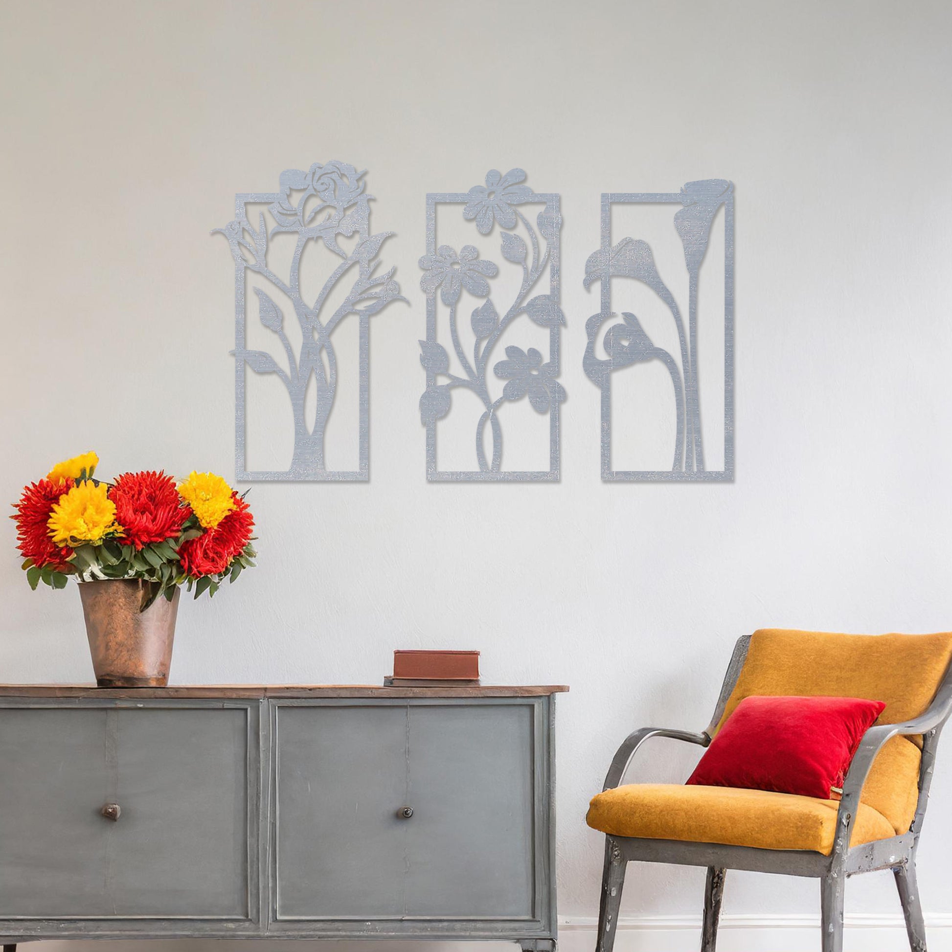 Wall art featuring a triptych of floral designs, each panel showcasing distinct flowers such as roses, daisies, and calla lilies. The artwork is displayed on a neutral wall within modern decor, adding a natural and elegant touch to the space.