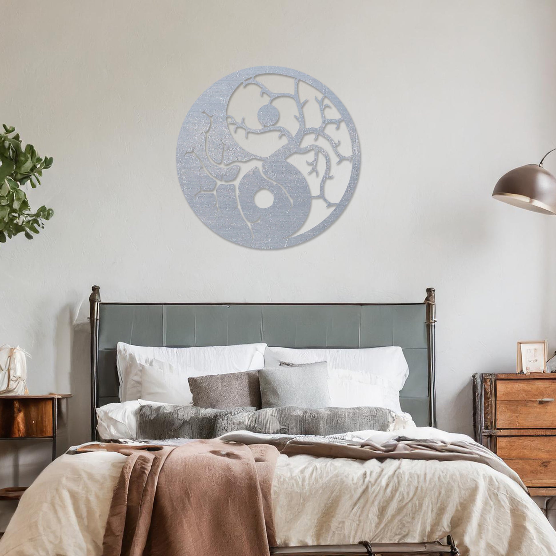 Wall art featuring a yin-yang design with tree branches integrated into each half, symbolising balance and harmony. The piece is displayed on a neutral wall within modern decor, adding a meaningful and artistic focal point to the space.