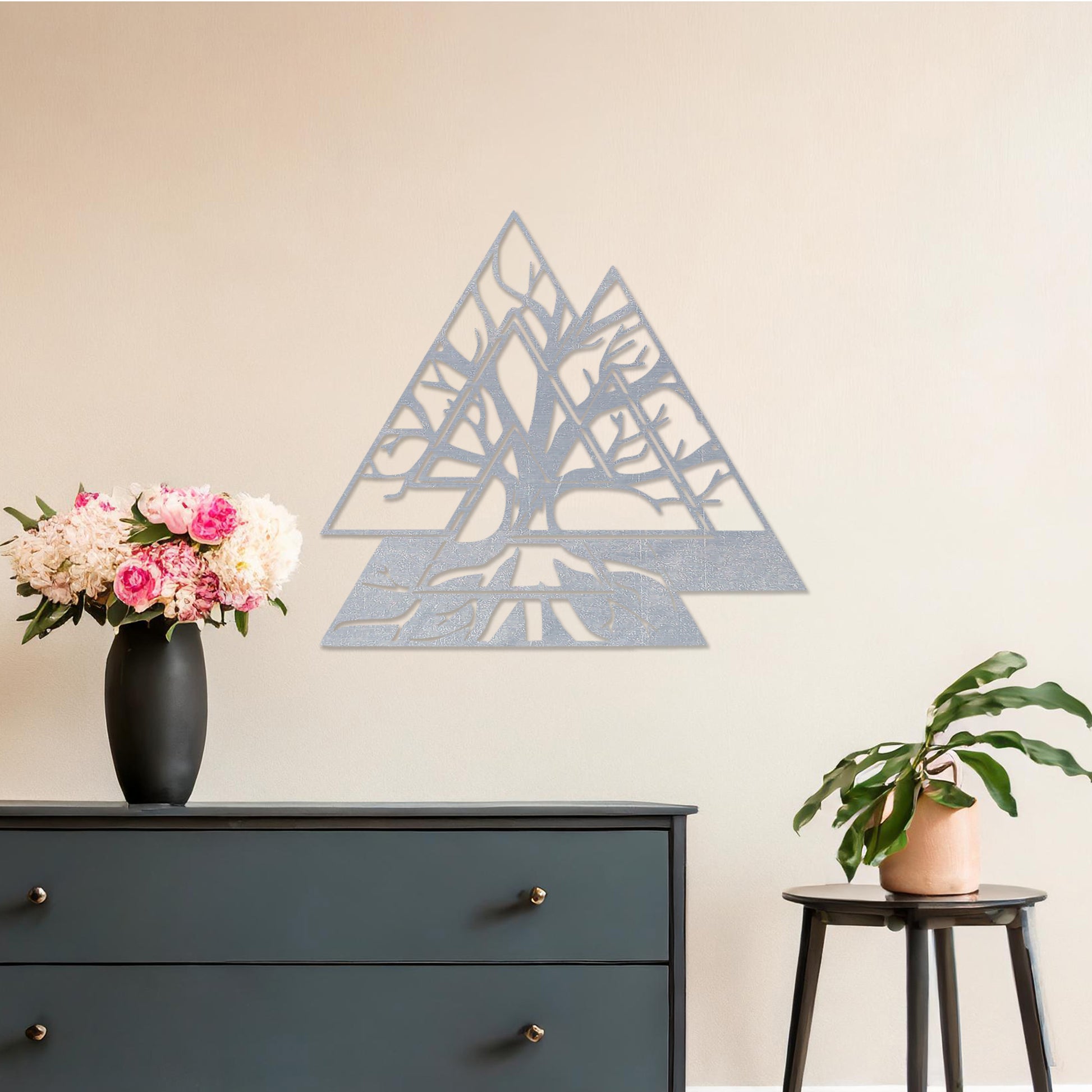 Wooden wall art design featuring a geometric triangular shape with intricate tree branches interwoven inside, placed on a neutral wall within modern room decor. The design combines nature and geometry for a contemporary, artistic expression.