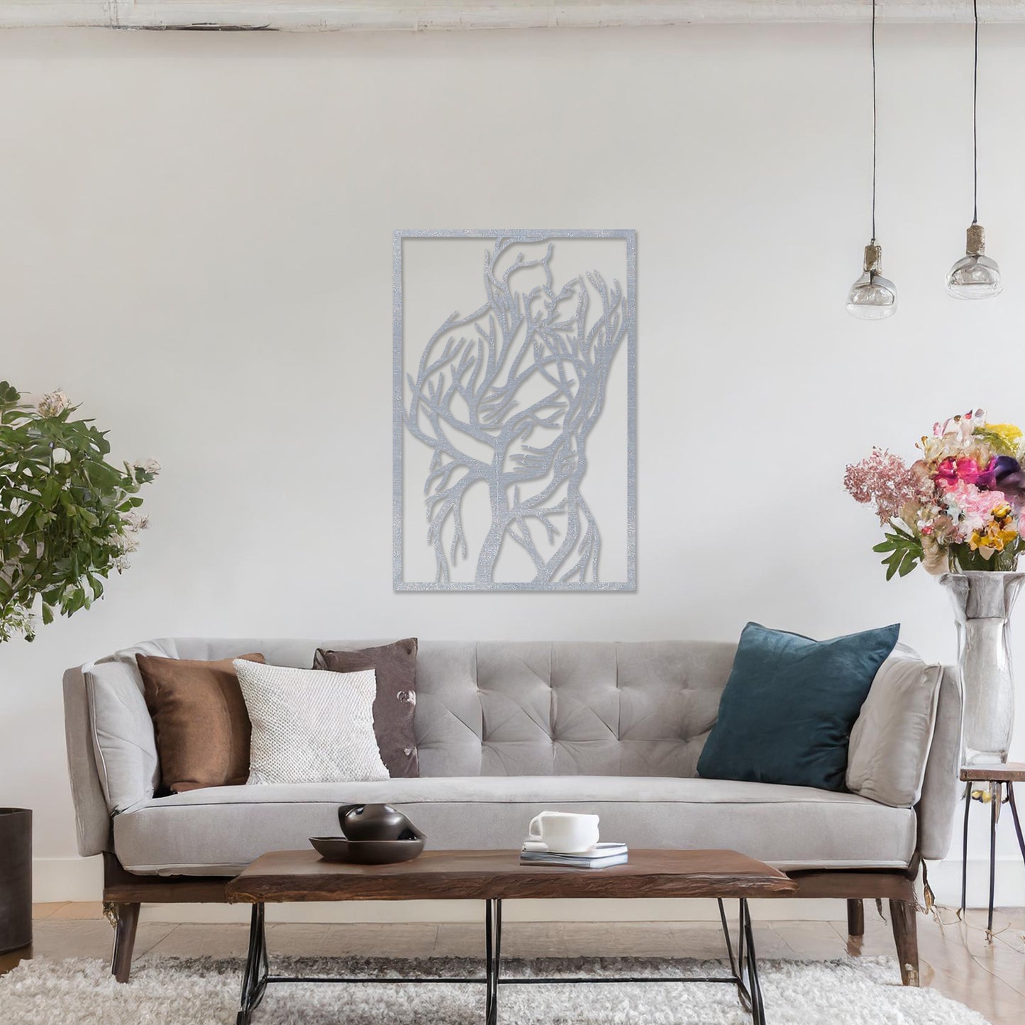 Wooden wall art featuring a rectangular design of two intertwined human figures stylised with tree branches, symbolising connection and unity. The artwork is displayed on a neutral wall within modern room decor, highlighting its artistic and emotional depth.
