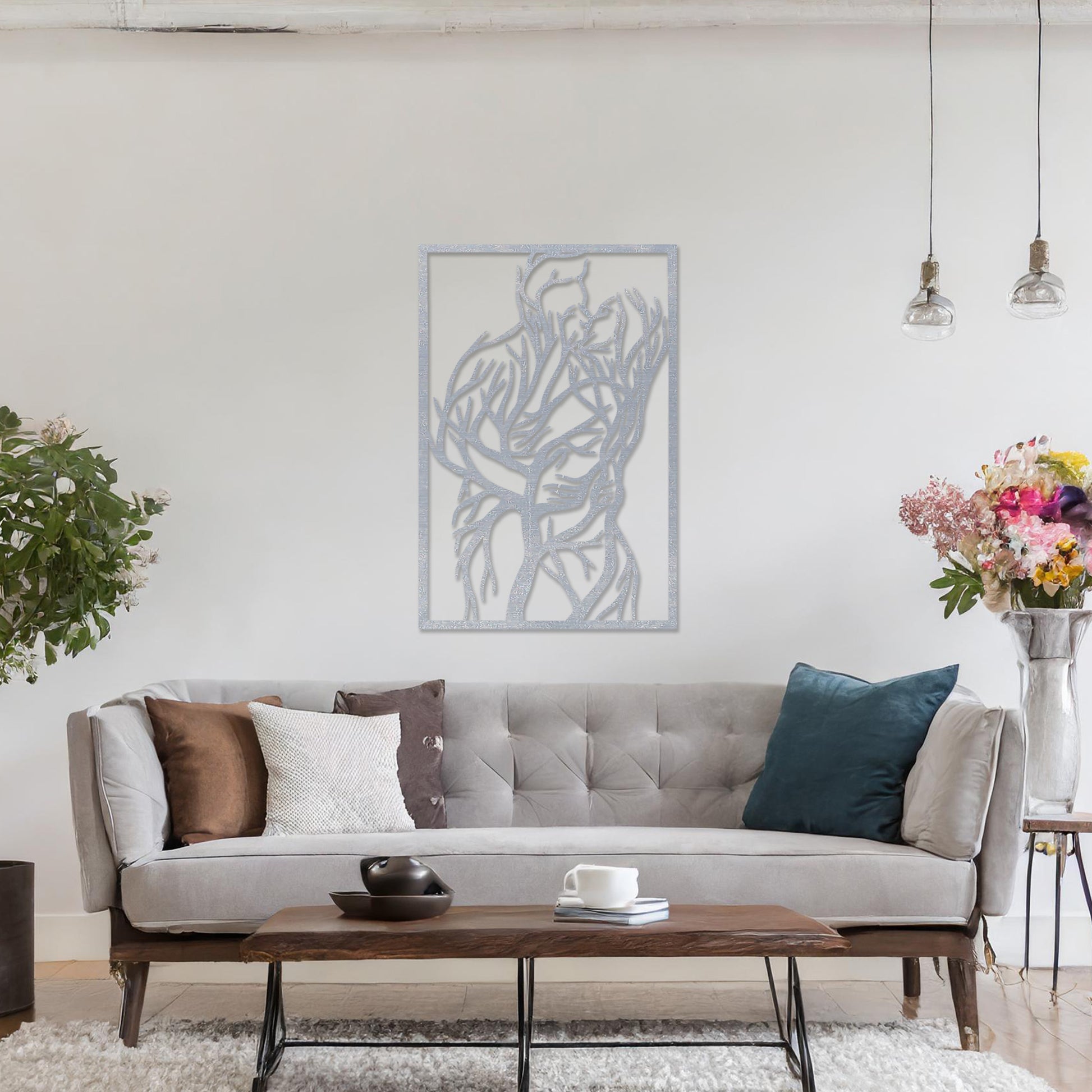 Wooden wall art featuring a rectangular design of two intertwined human figures stylised with tree branches, symbolising connection and unity. The artwork is displayed on a neutral wall within modern room decor, highlighting its artistic and emotional depth.