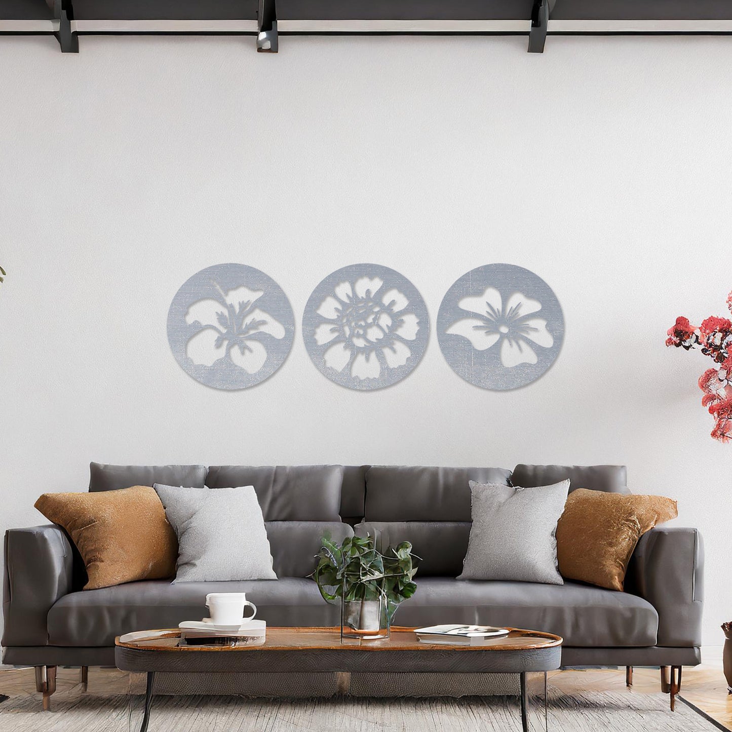 Wall art featuring a set of three circular panels, each showcasing a distinct floral design with intricate cut-out details. The artwork is displayed on a neutral wall within modern decor, adding a charming and decorative touch to the space.