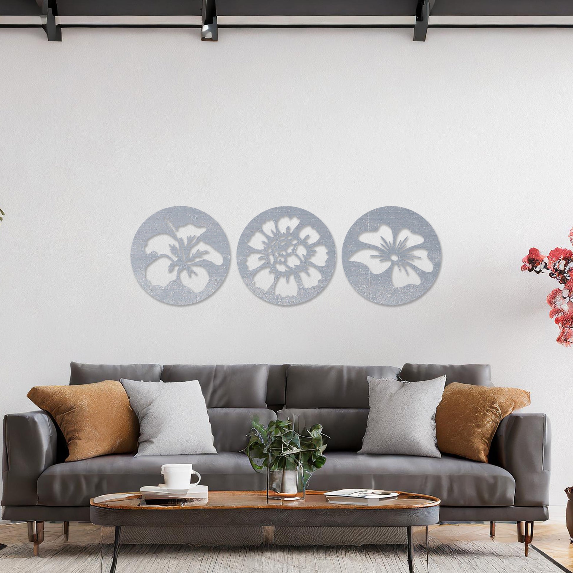 Wall art featuring a set of three circular panels, each showcasing a distinct floral design with intricate cut-out details. The artwork is displayed on a neutral wall within modern decor, adding a charming and decorative touch to the space.