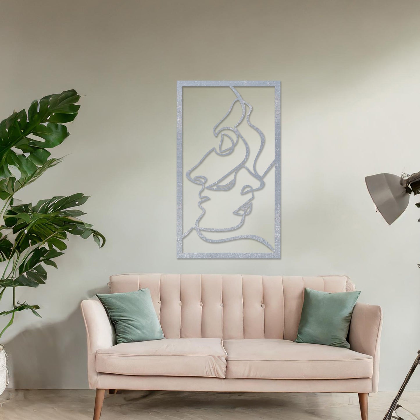 Wooden wall art design featuring abstract line art of two faces, placed on a neutral wall with modern room decor. The design is minimalistic and elegant, capturing human forms through flowing lines.