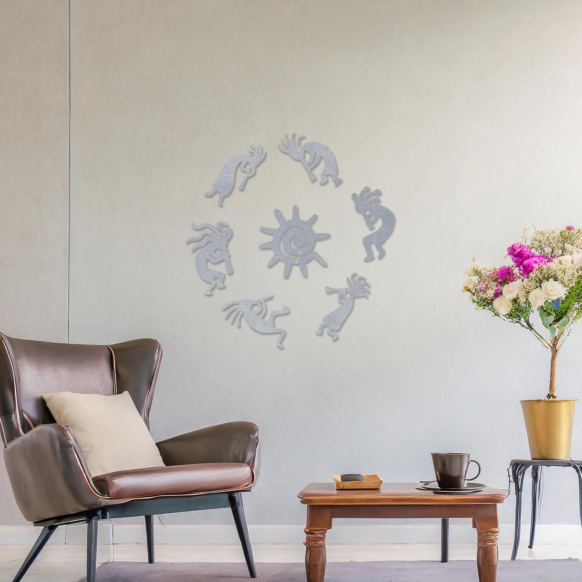 Wooden wall art featuring a circular arrangement of dancing figures surrounding a central sun design. The artwork is displayed on a neutral wall within modern room decor, highlighting its tribal and artistic charm.