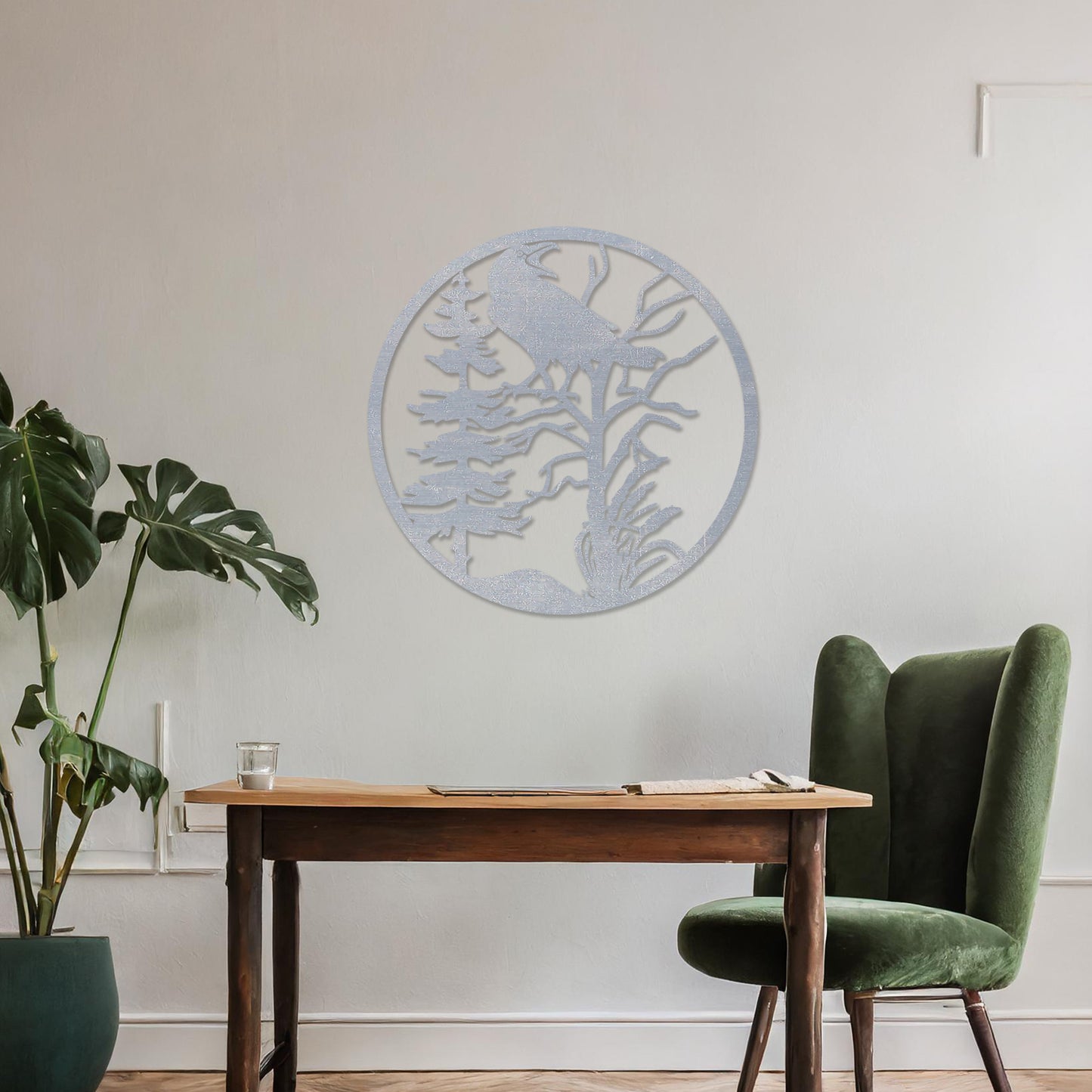 Wooden wall art featuring a circular design with a silhouette of a bird perched on a tree surrounded by natural elements. The artwork is displayed on a neutral wall within modern room decor, highlighting its rustic and nature-inspired design.
